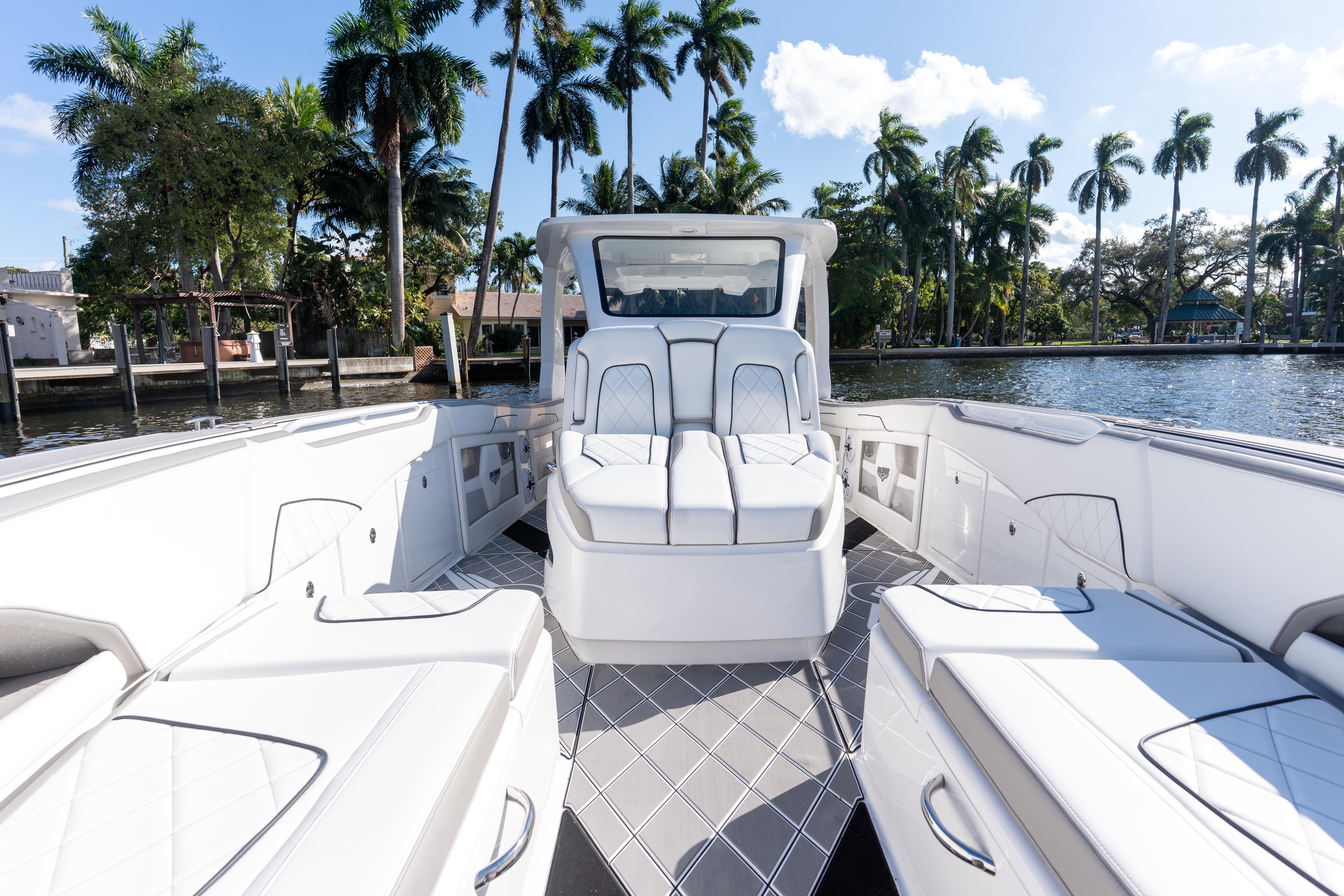 Luxury interior of 2026 Deep Impact 399 Sport boat with elegant seating and scenic waterfront view.