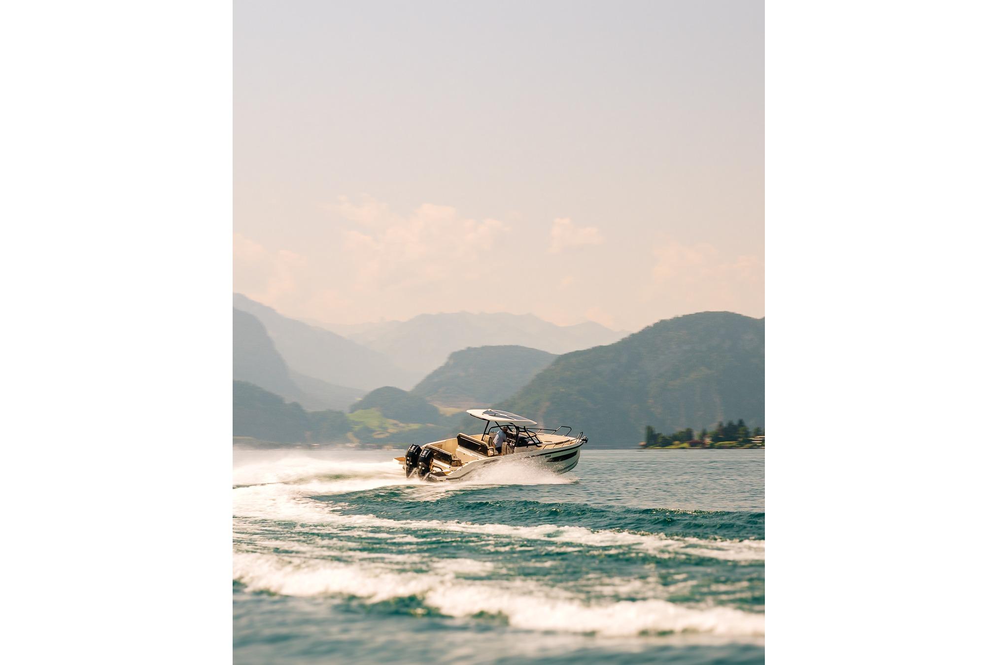 Navan S30 boat 2026 cruising on a lake with mountain backdrop.