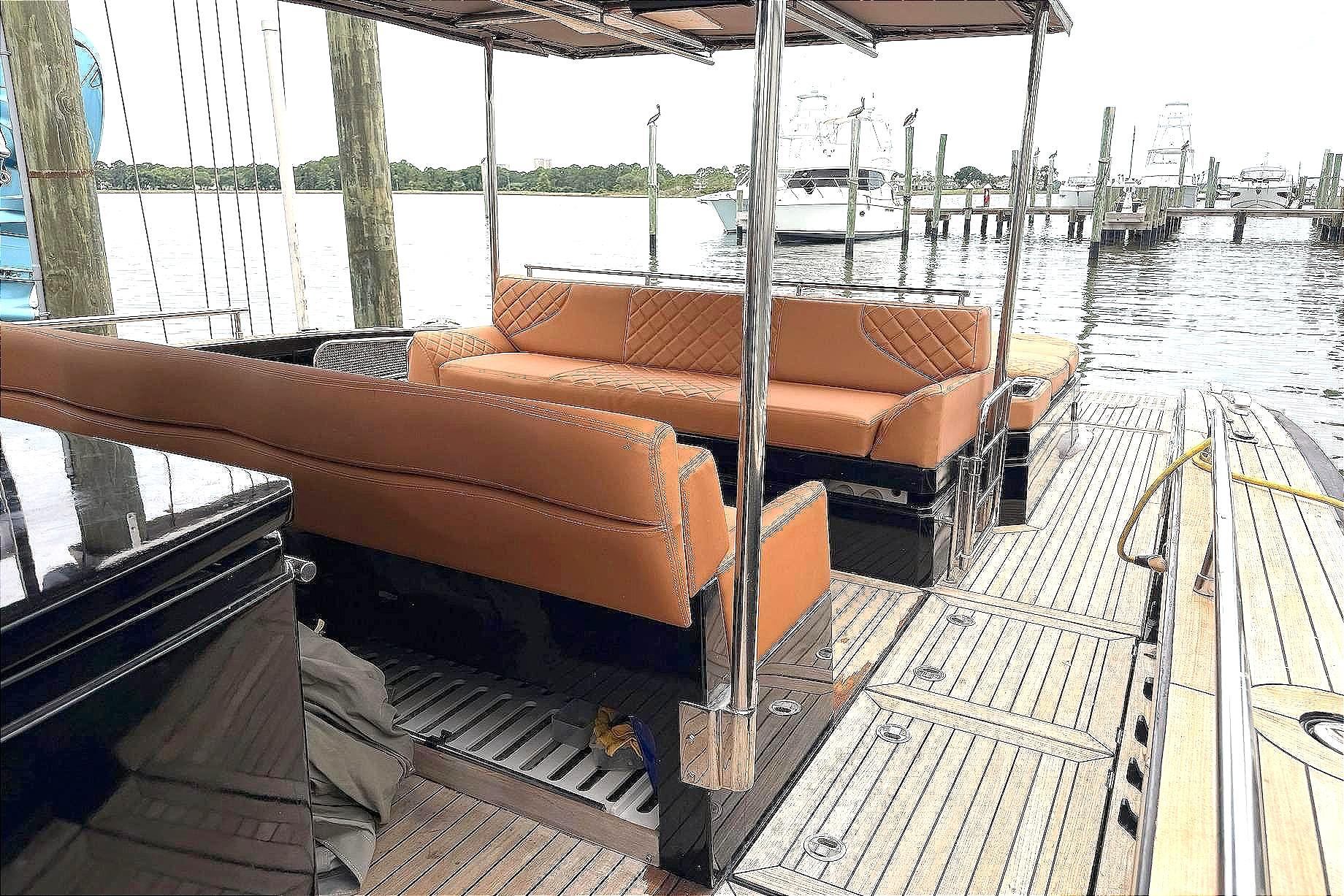 Luxurious 2013 Windy SR52 yacht interior with tan leather seating and wooden deck.
