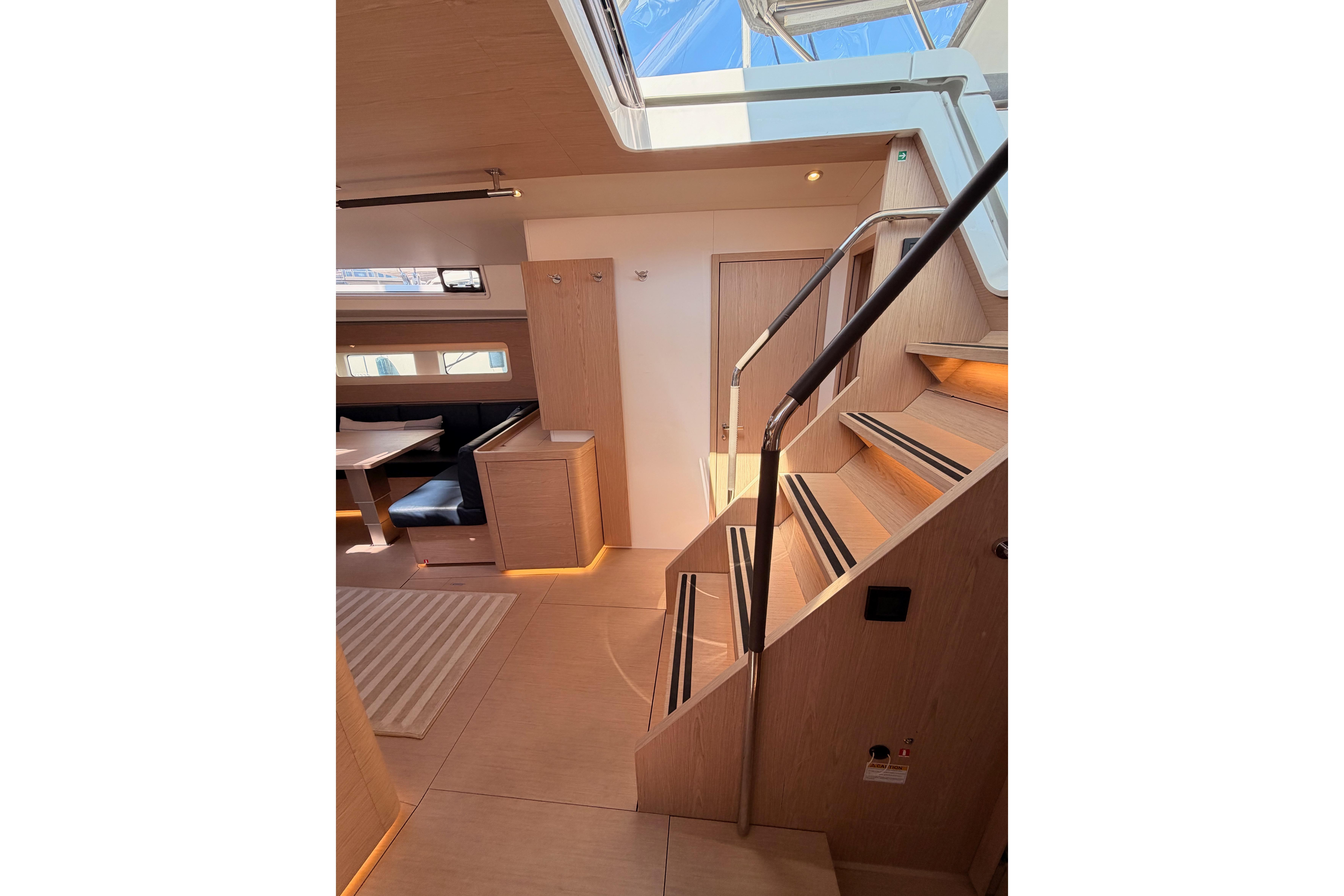 Luxurious interior of 2022 Beneteau Oceanis Yacht 54, featuring elegant wood finishes and modern design.