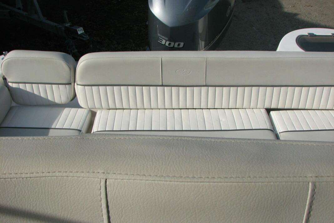 2020 Sea Fox 249 Avenger boat seating with white upholstery and visible engine.