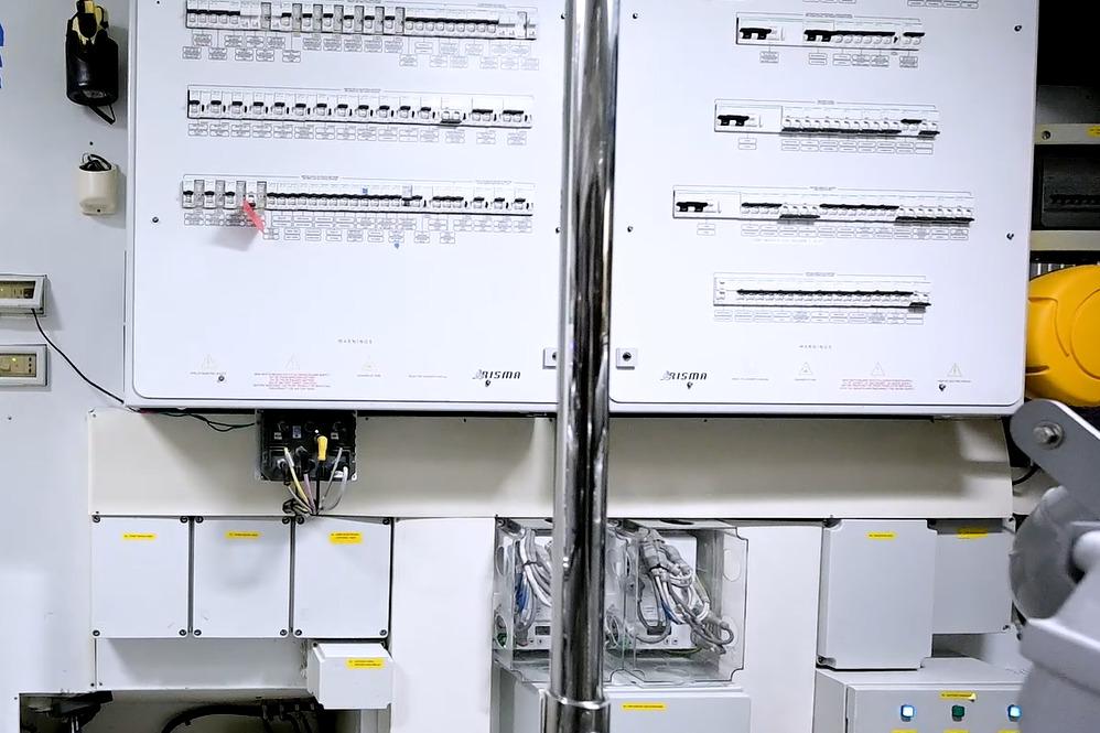 Electrical control panel inside a 2015 Pershing 92 yacht, featuring various switches and wiring.
