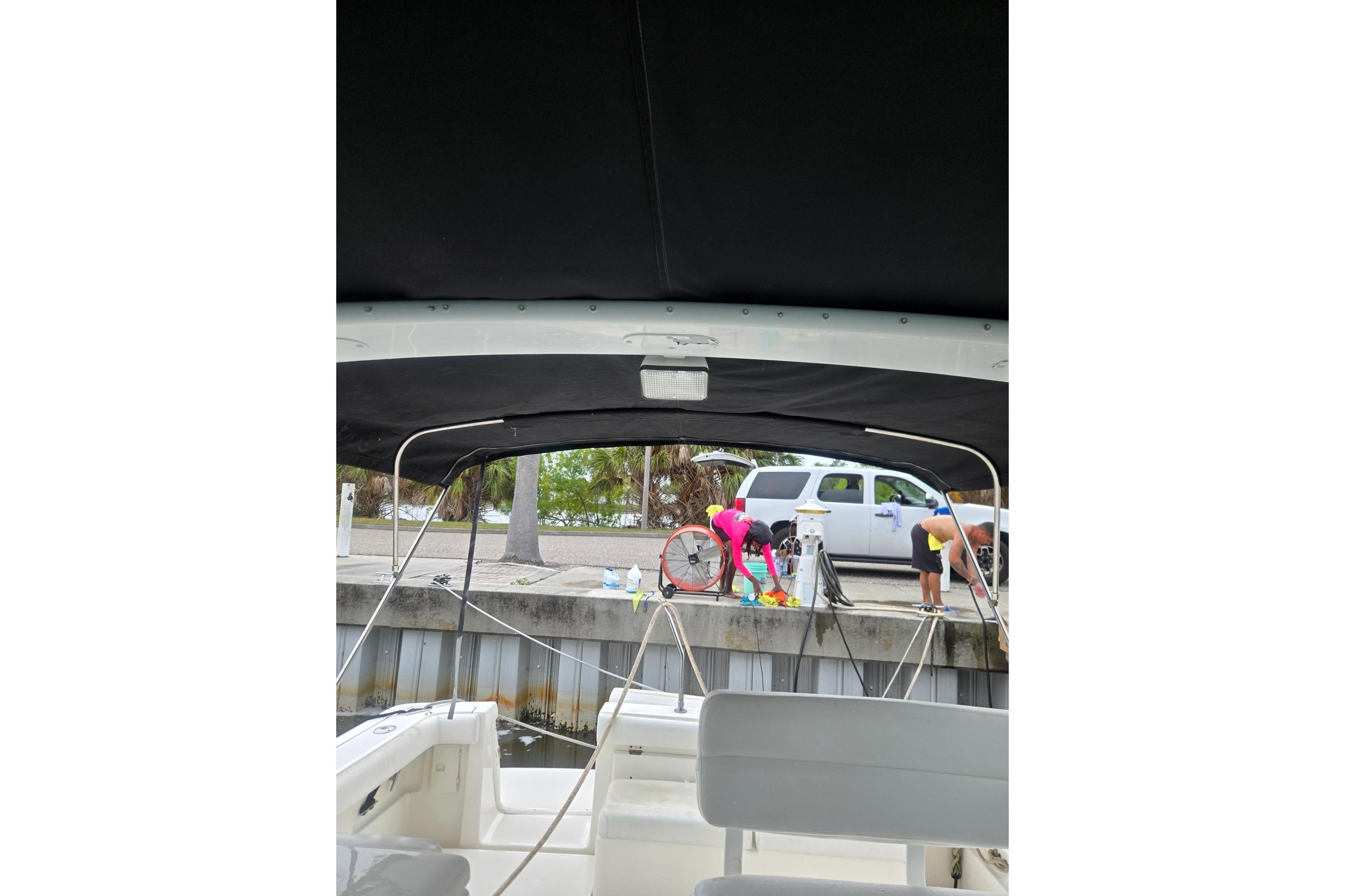 2002 Tiara Yachts 3500 Open view from interior, dockside with people and vehicle.
