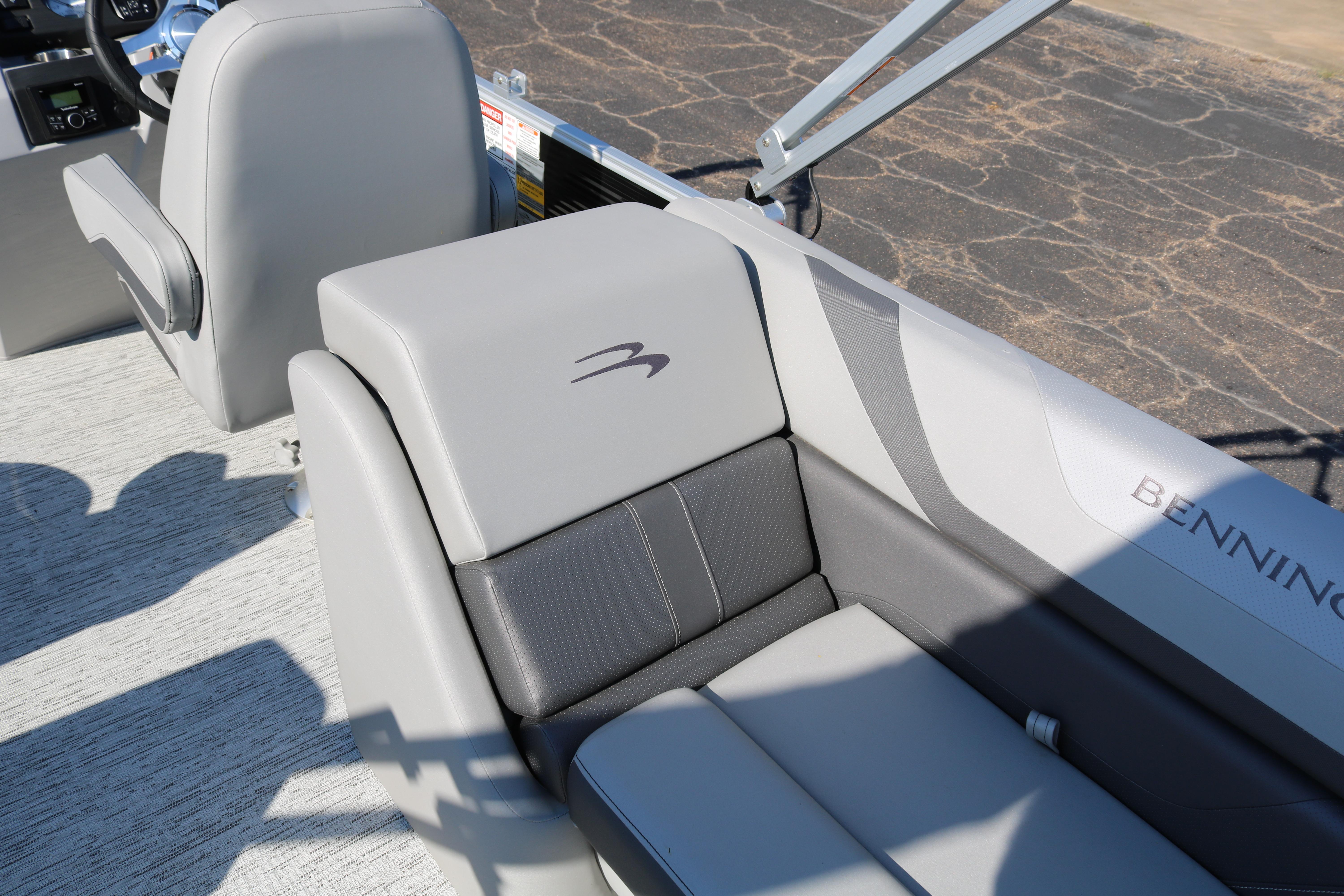 2026 Bennington 22SX Stern Radius boat interior with gray seating and logo detail.