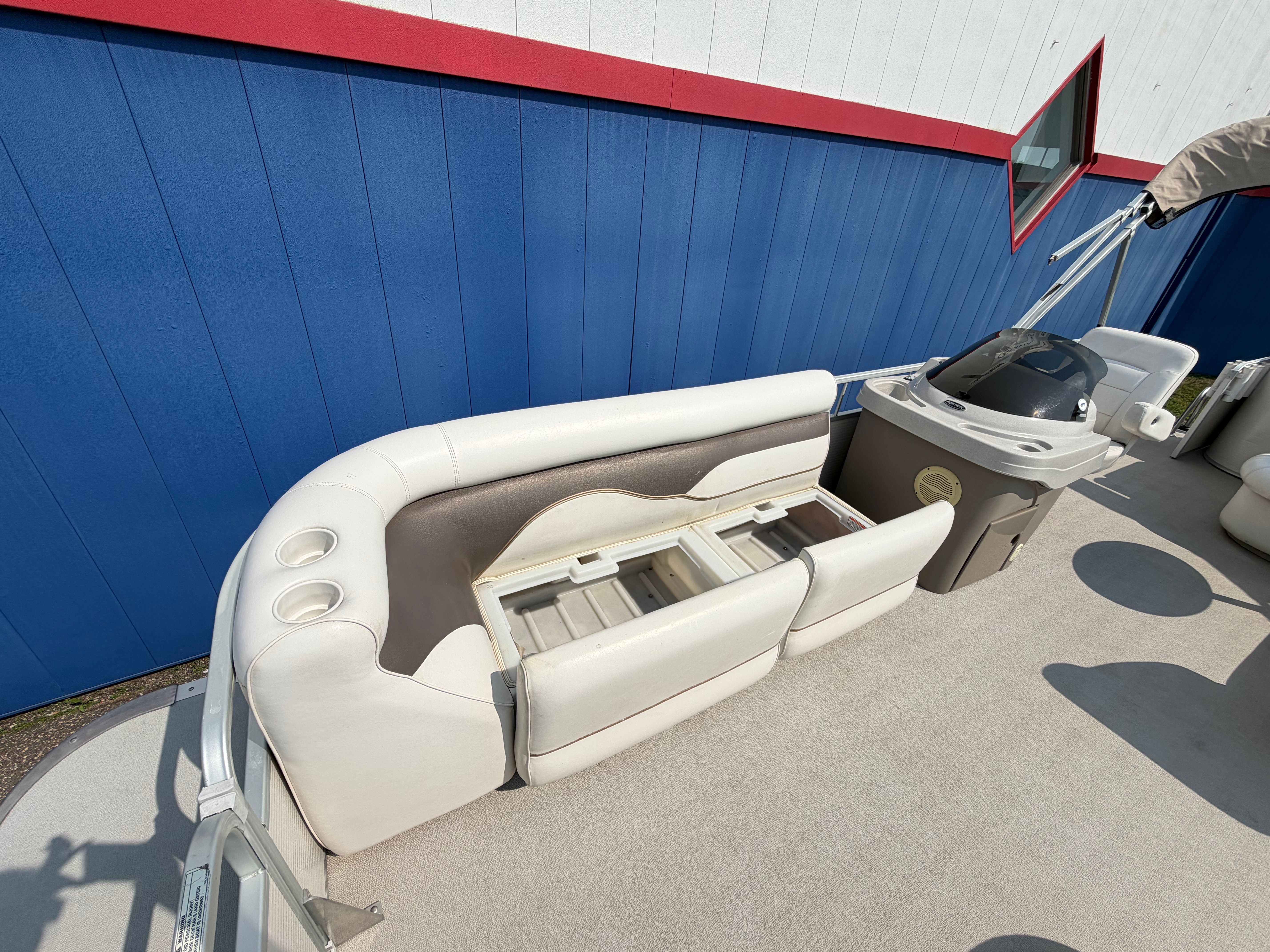 The image shows the interior of a 2007 Premier 225 Sunsation pontoon boat with white seating.