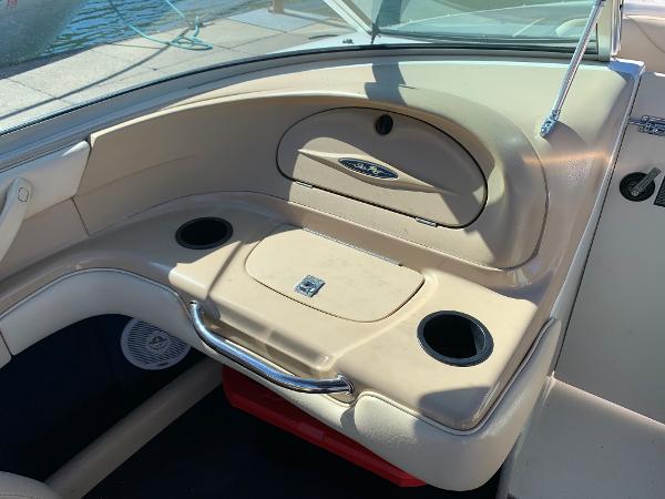 Interior of a 2000 Sea Ray 210 Bow Rider boat with cup holders and storage compartments.
