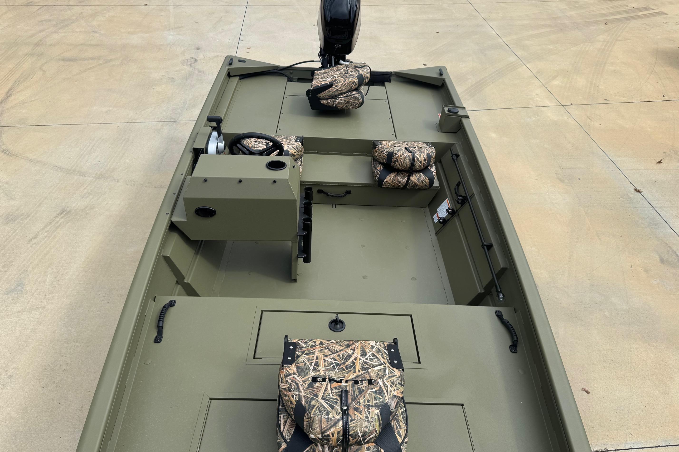 2026 Lund 1760 Predator SC boat interior with camouflage seats and steering console.