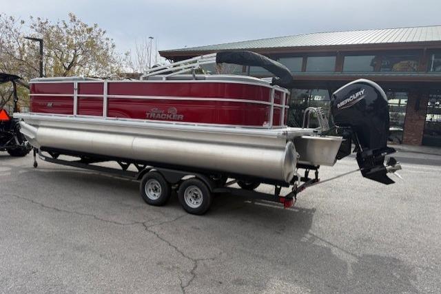2026 Sun Tracker Party Barge 22 DLX pontoon boat on trailer, parked outdoors.
