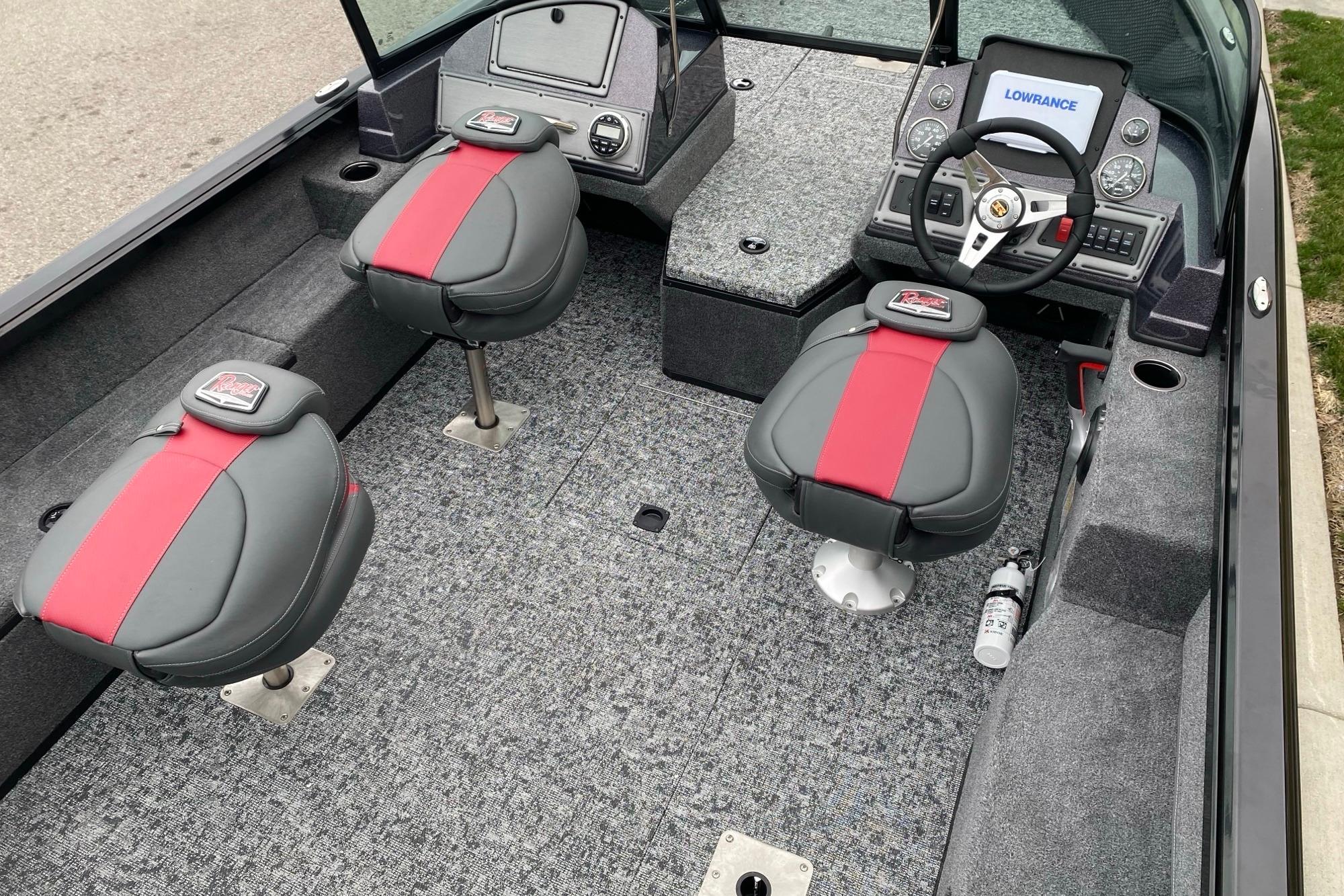 2026 Ranger VS1882SC Angler boat interior with red and gray seating, steering console, and carpeted floor.