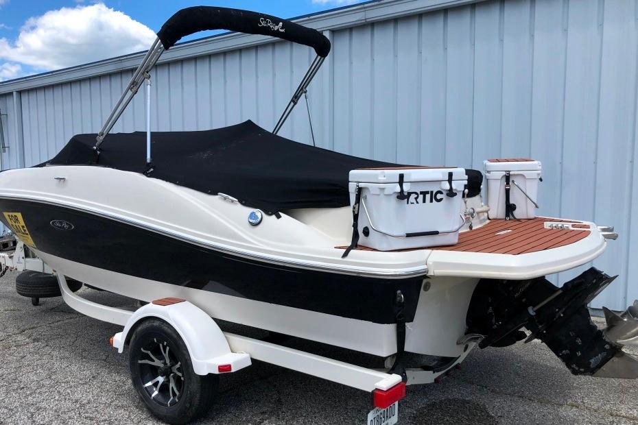 2006 Sea Ray 185 Sport boat on trailer, covered, with RTIC cooler on deck.