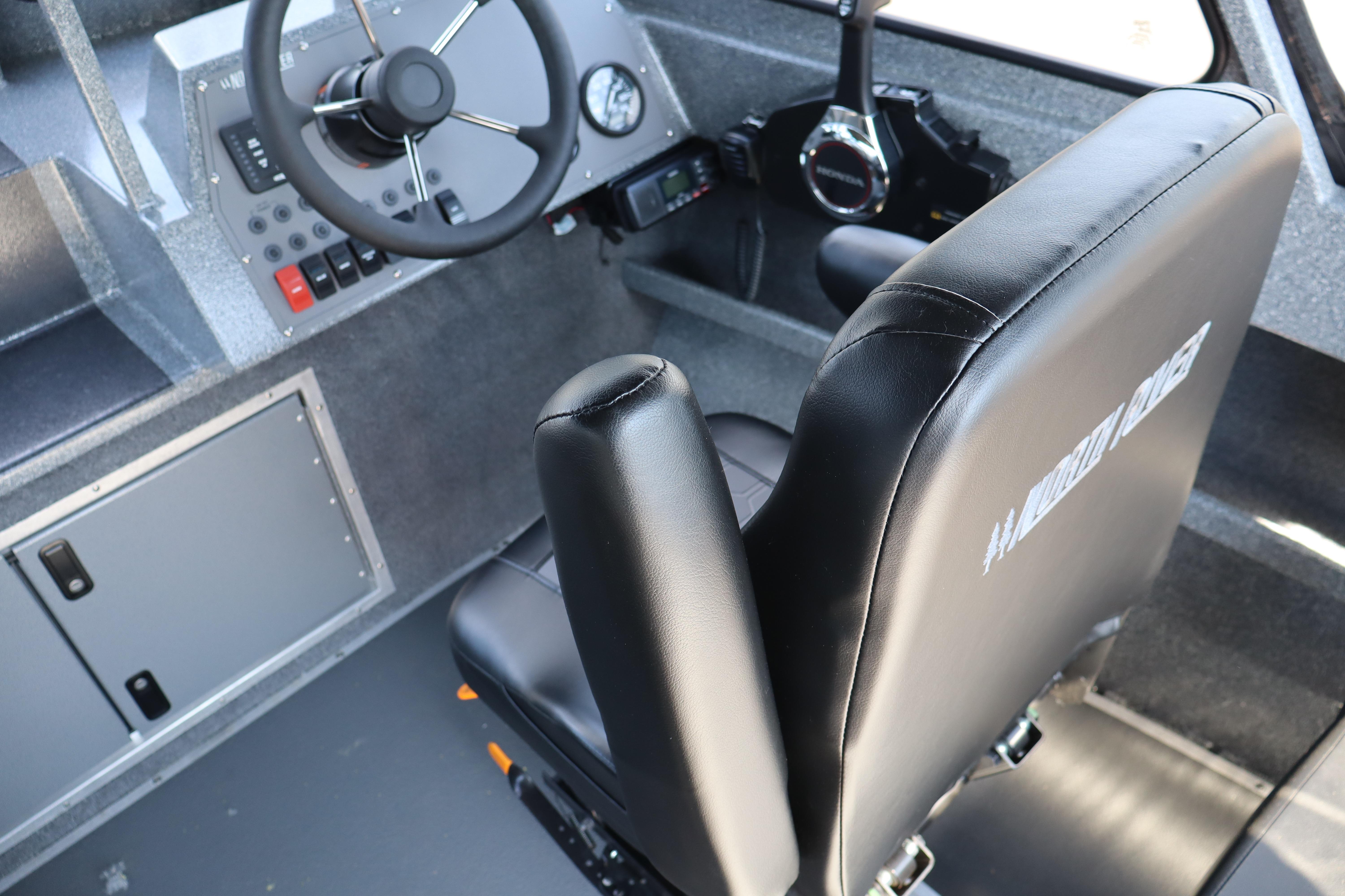 Interior of 2025 NorthRiver SEAHAWK boat, featuring steering wheel and control panel.