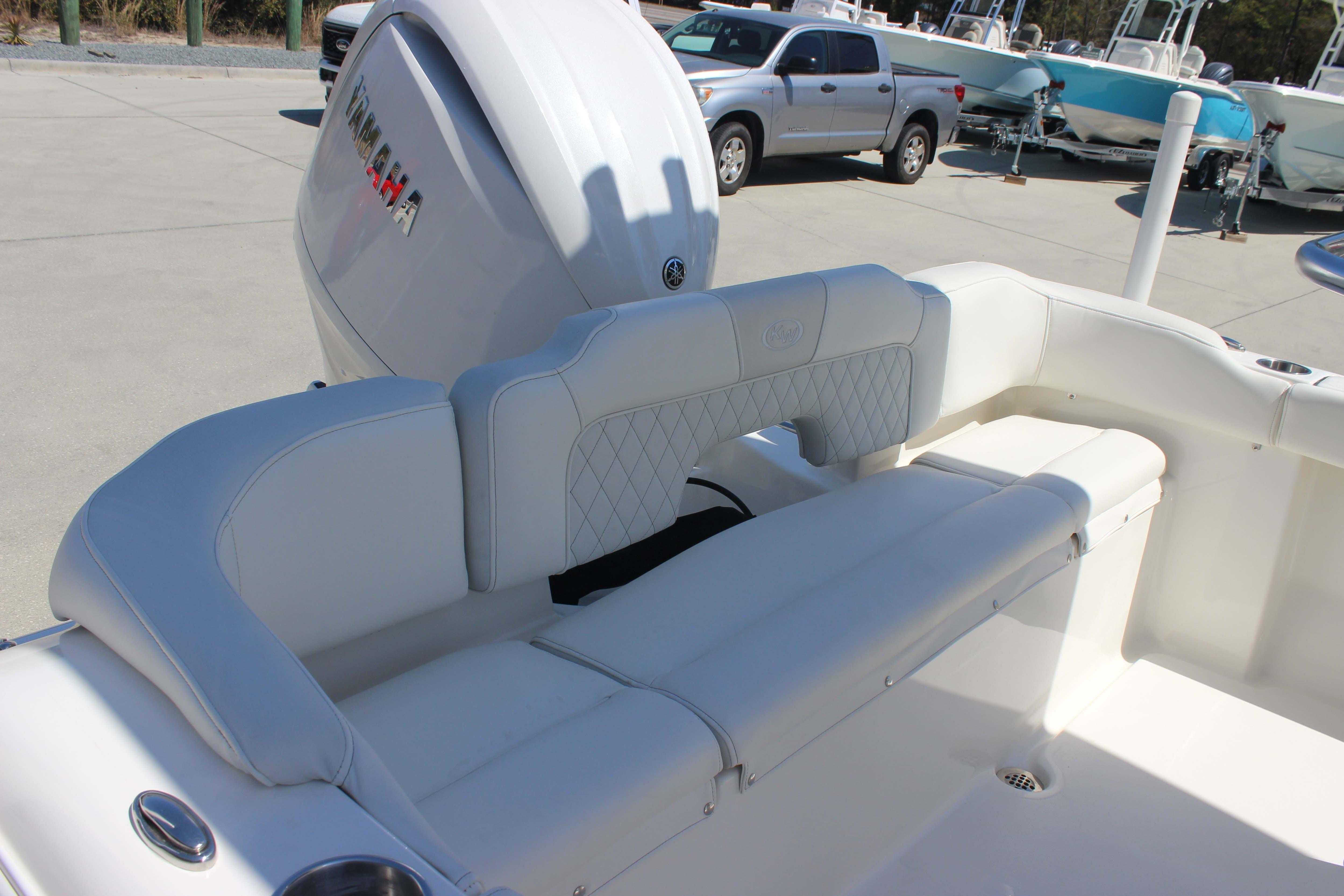 2026 Key West 203 FS boat with Yamaha engine, featuring white cushioned seating.