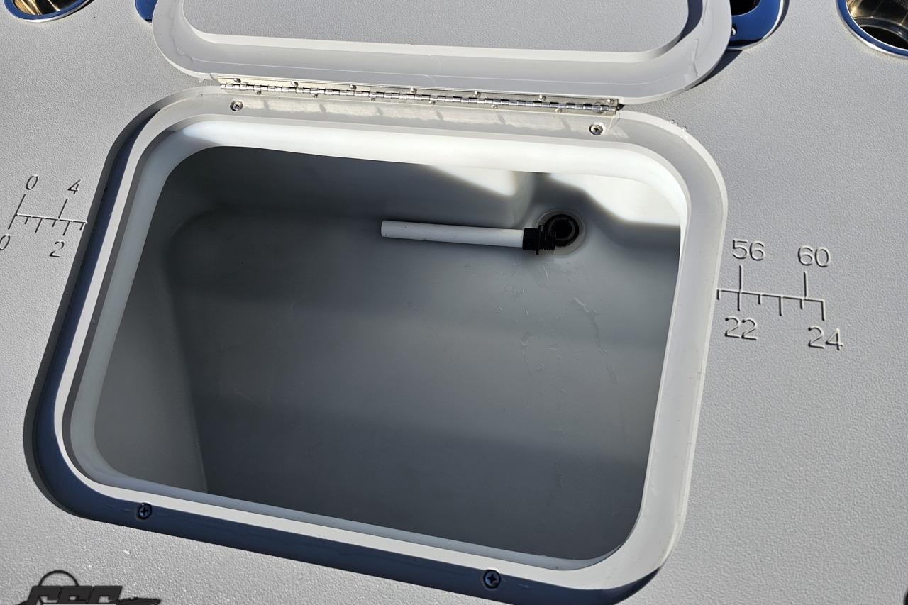 Open storage compartment on 2022 Bennington SX 21 Fishing boat with measurement markings.