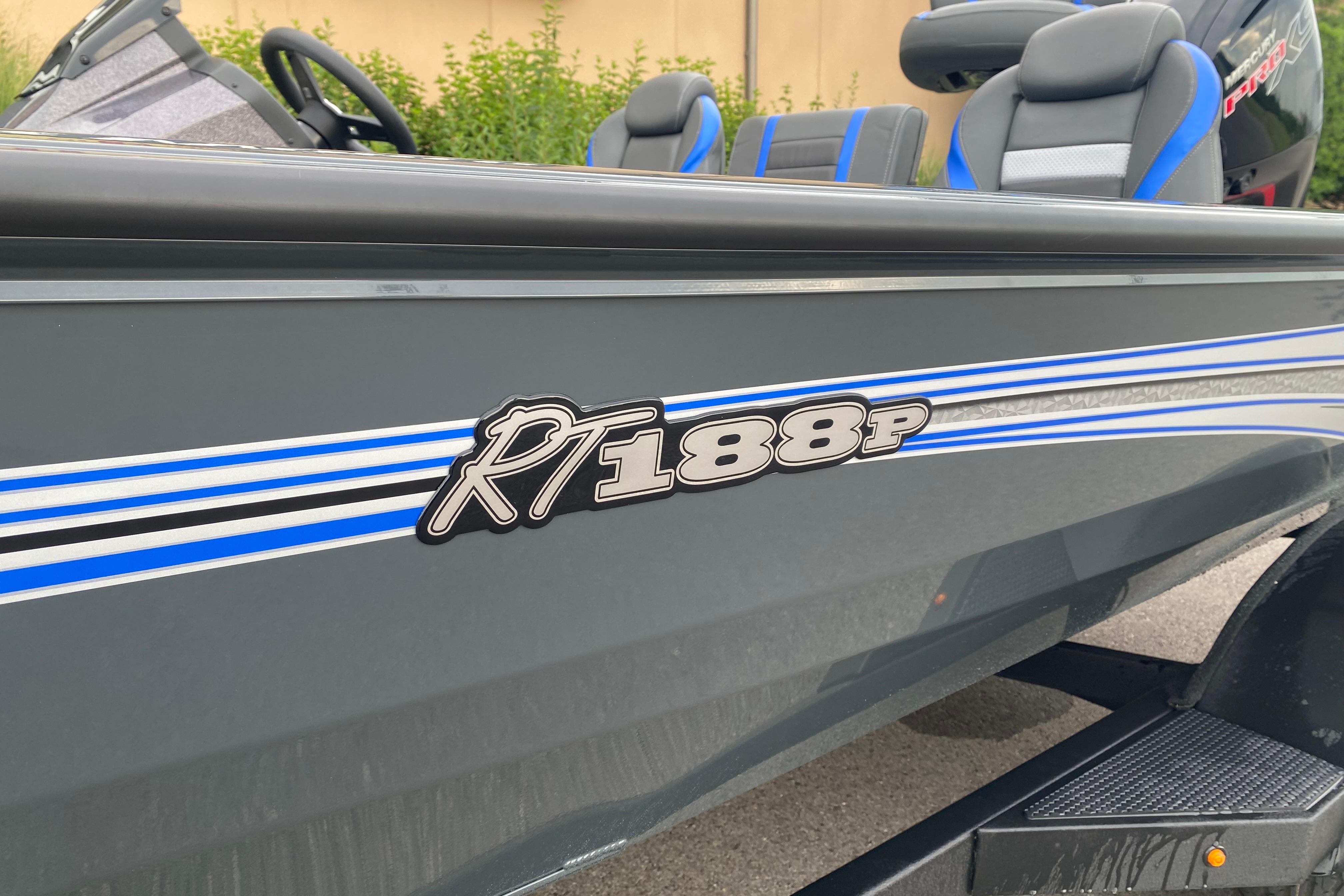 2026 Ranger RT188P boat with blue and white stripes, featuring comfortable seating.