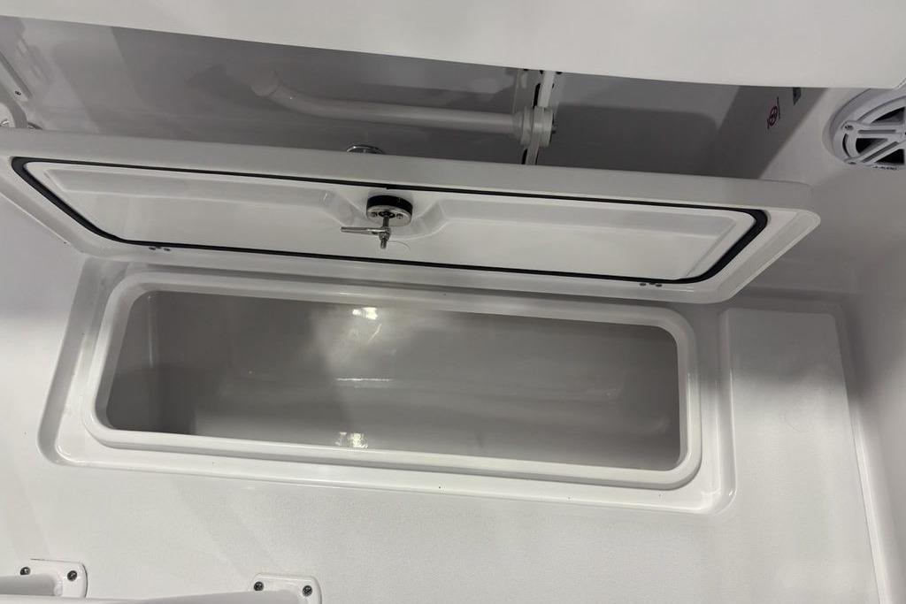 2026 Sportsman Open 252 Center Console storage compartment with open lid.