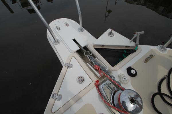 Bow of a boat with anchor windlass and chain guide.
