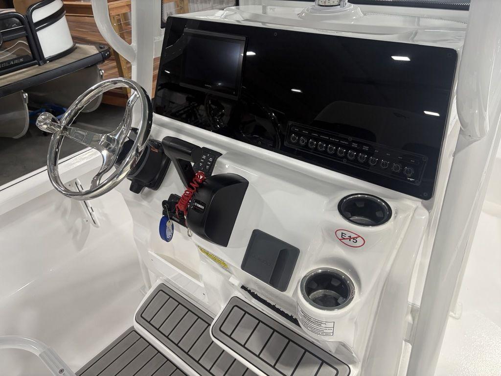 2026 Tidewater 2110 BM boat console with steering wheel, controls, and cup holders.