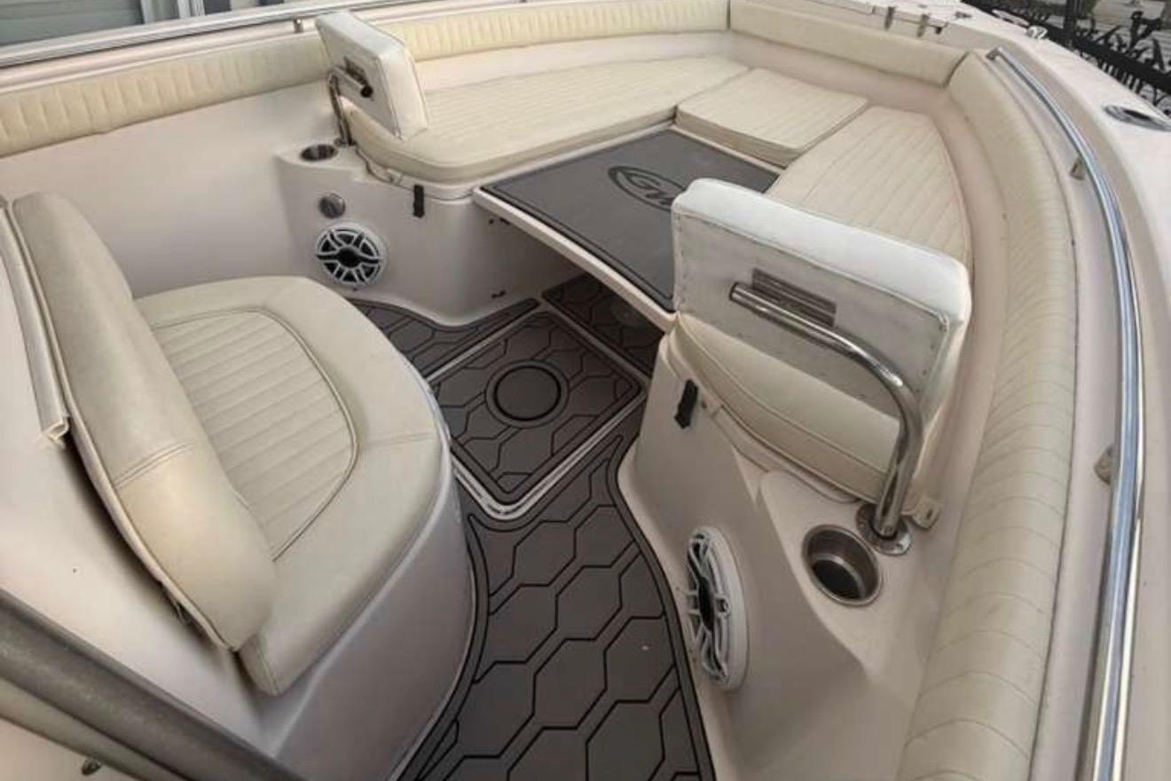 2004 Grady-White Chase 273 boat interior with cushioned seating and modern flooring.