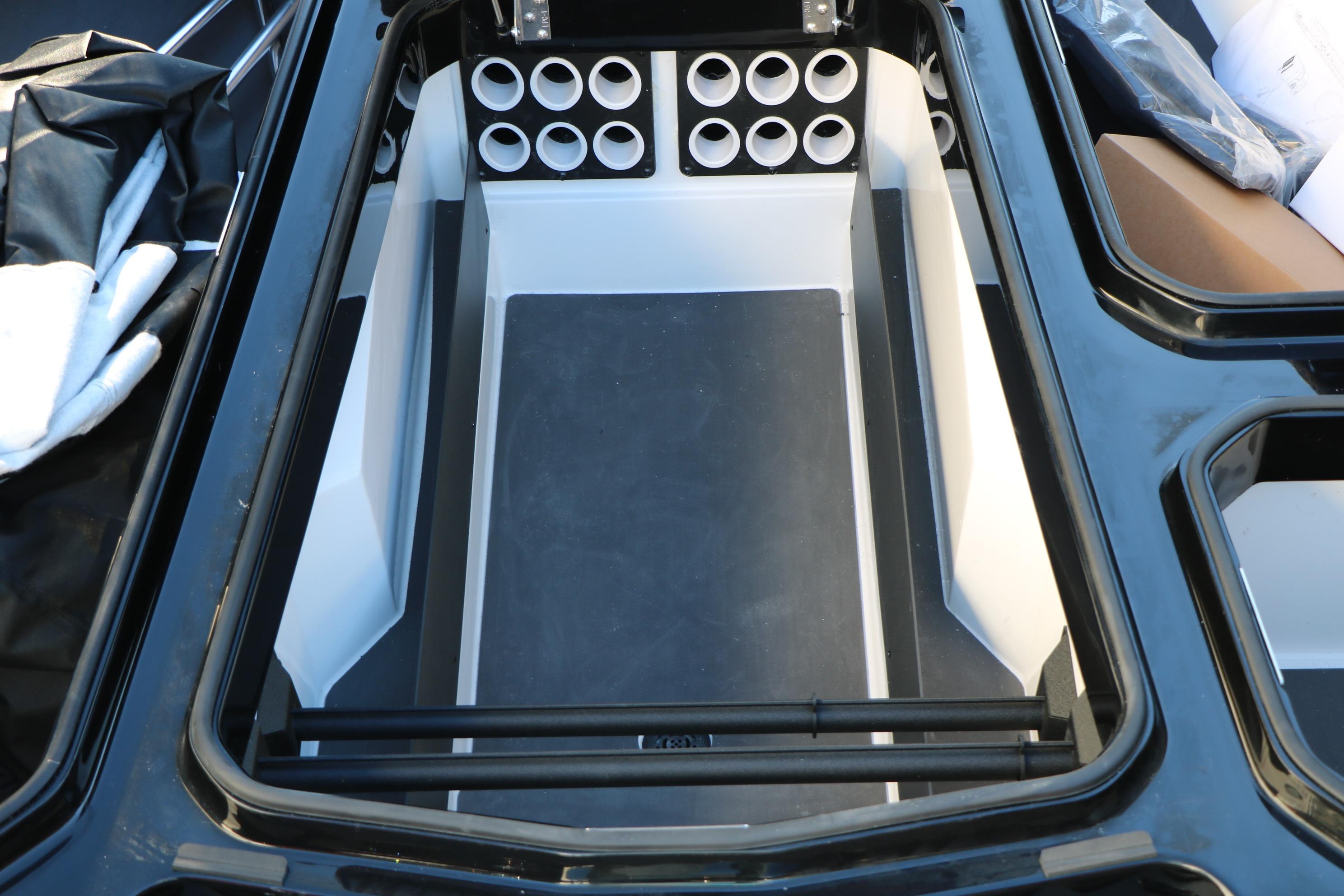 Interior storage compartment of 2026 Vexus VXs21 boat with rod holders.