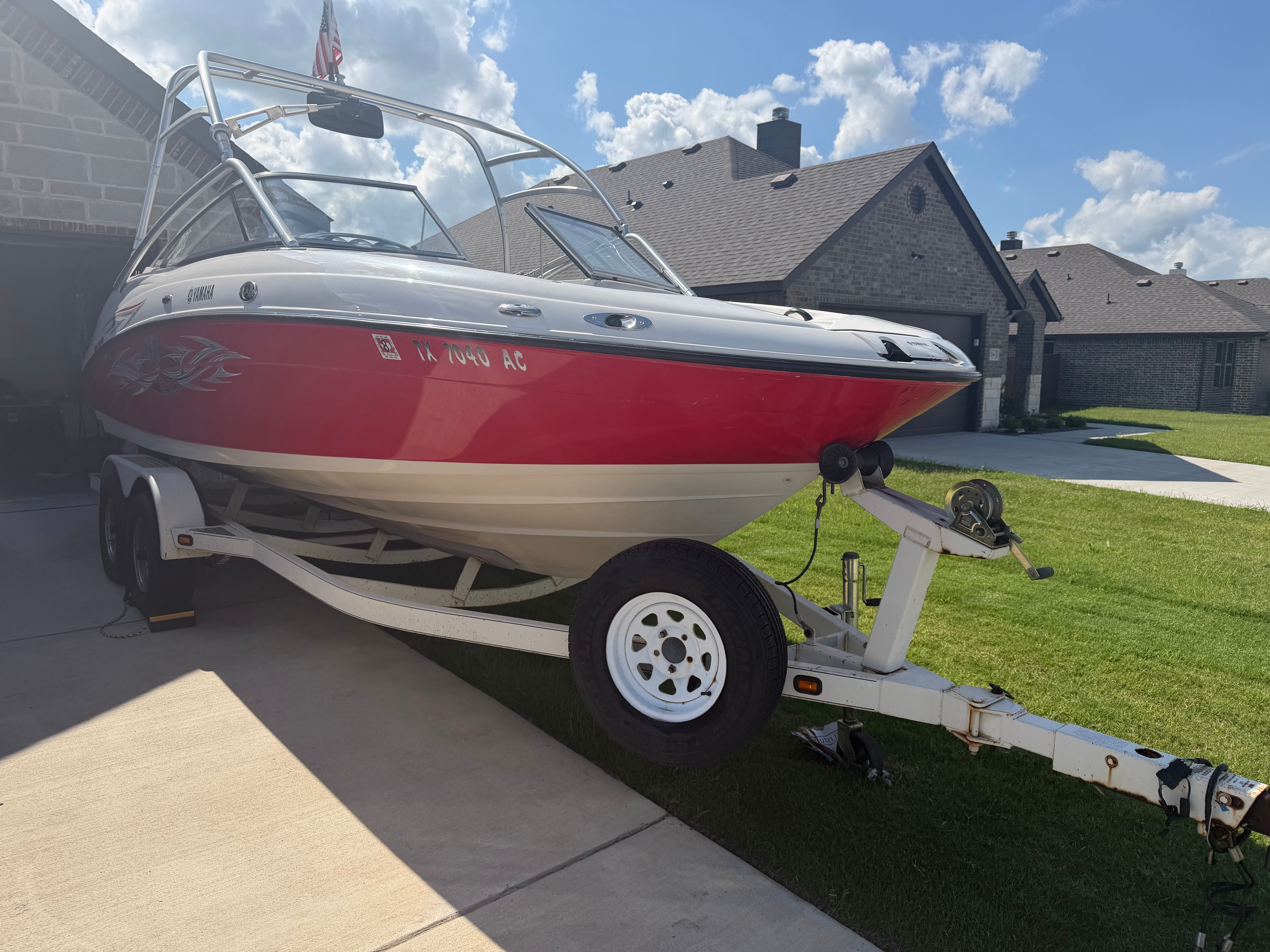 2006 Yamaha AR210 boat on trailer in driveway.