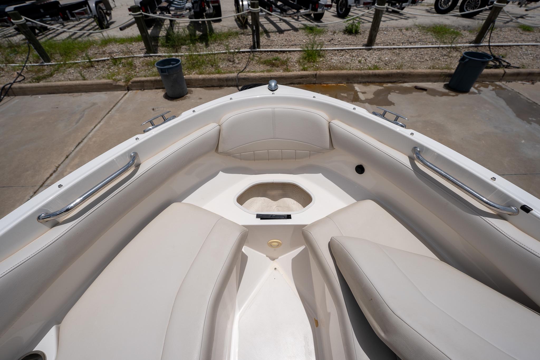 2008 Regal 2000 Bowrider boat interior with white seating and stainless steel handrails.