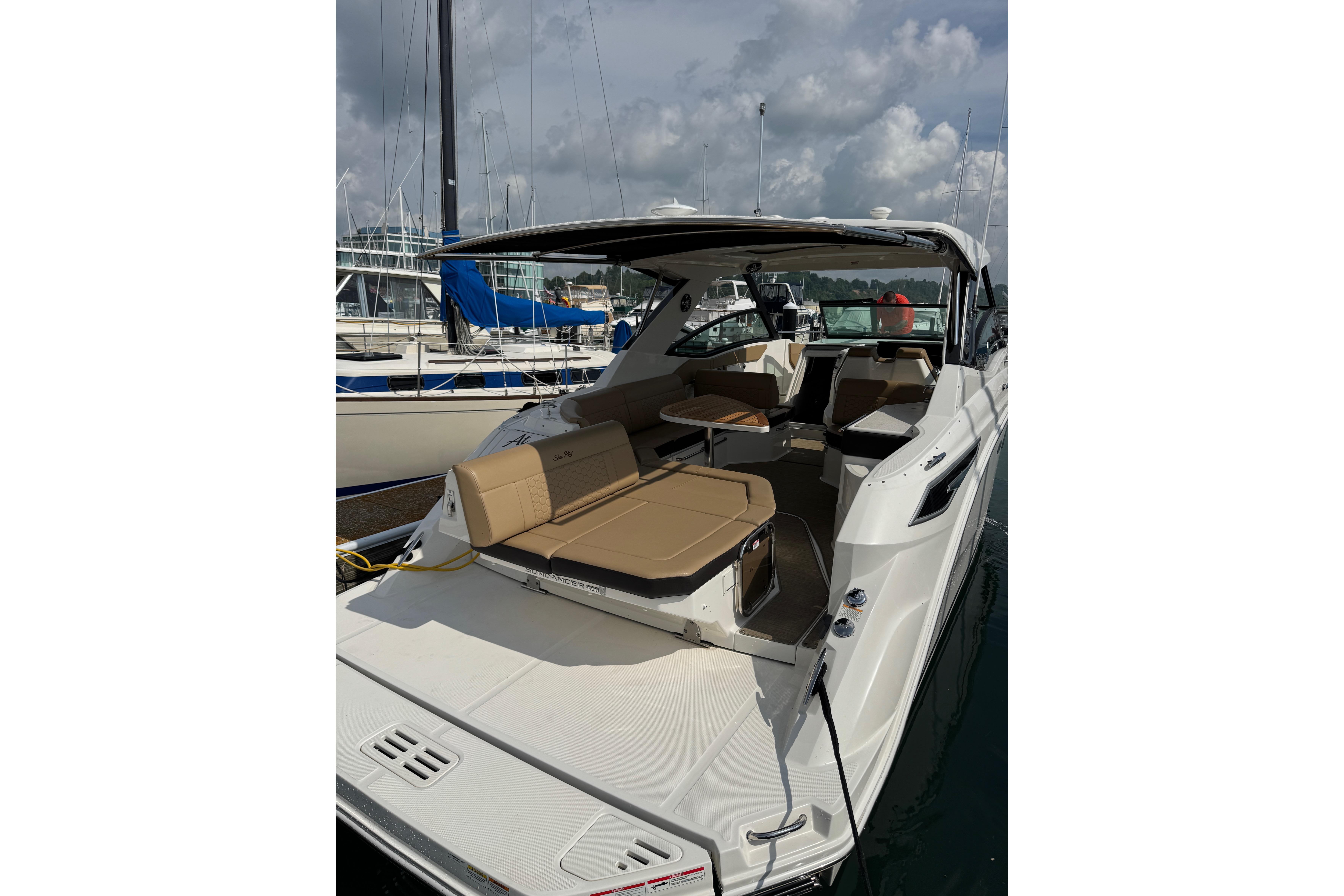 2019 Sea Ray Sundancer 320 yacht docked, featuring spacious seating and sleek design.