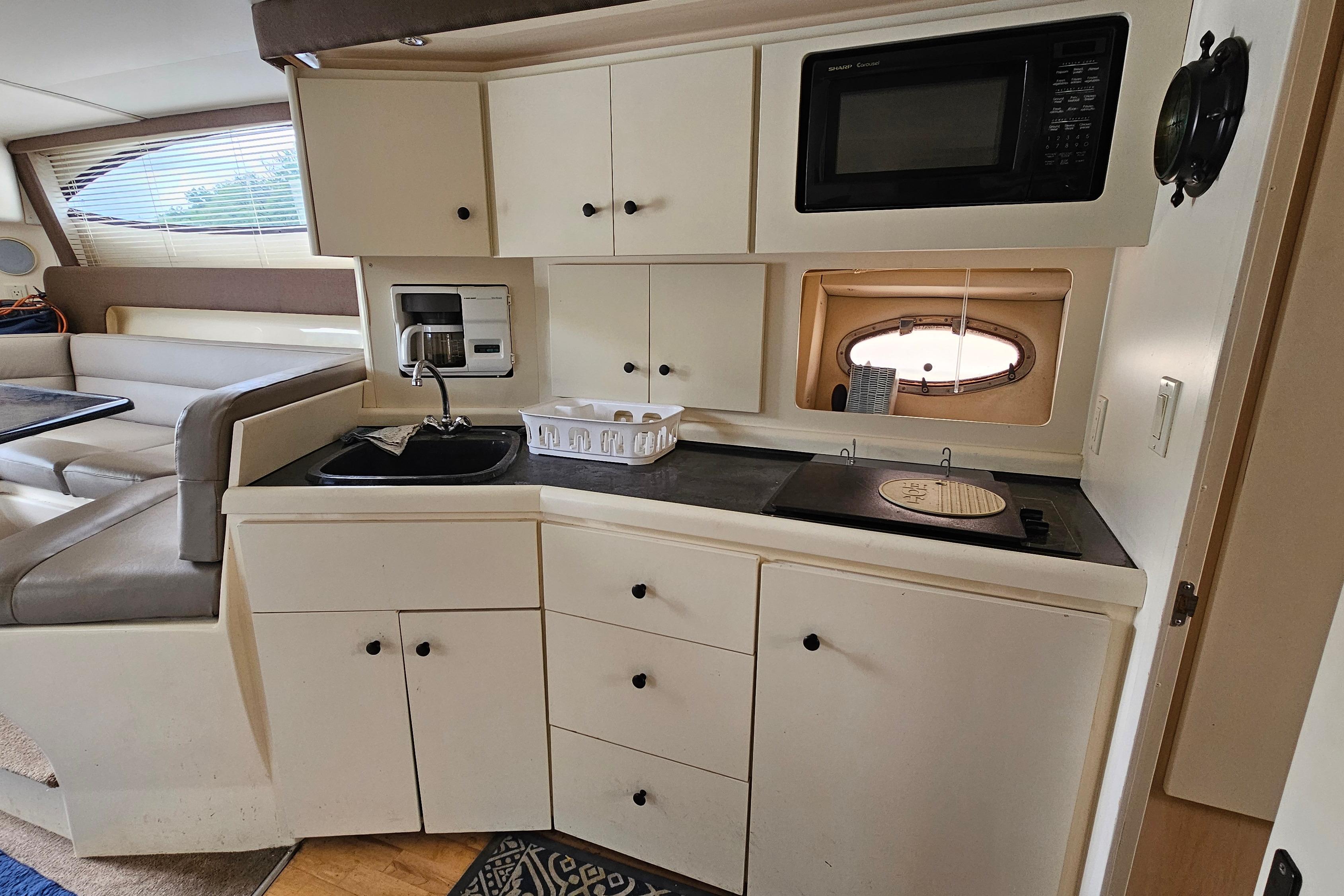 Interior of a 1999 Carver 350 Mariner yacht featuring a compact kitchen area.