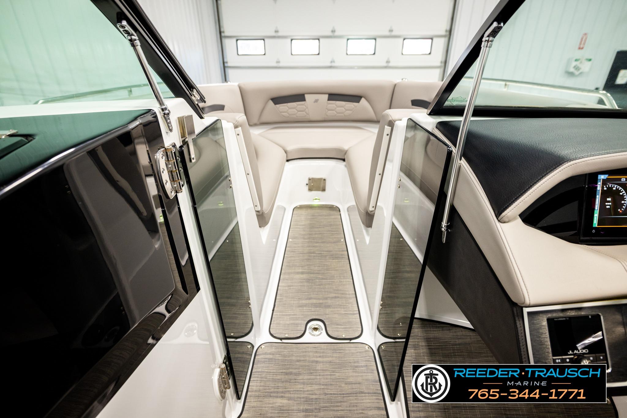 2024 FOURWINNS HD5 Surf boat interior with modern dashboard and seating.