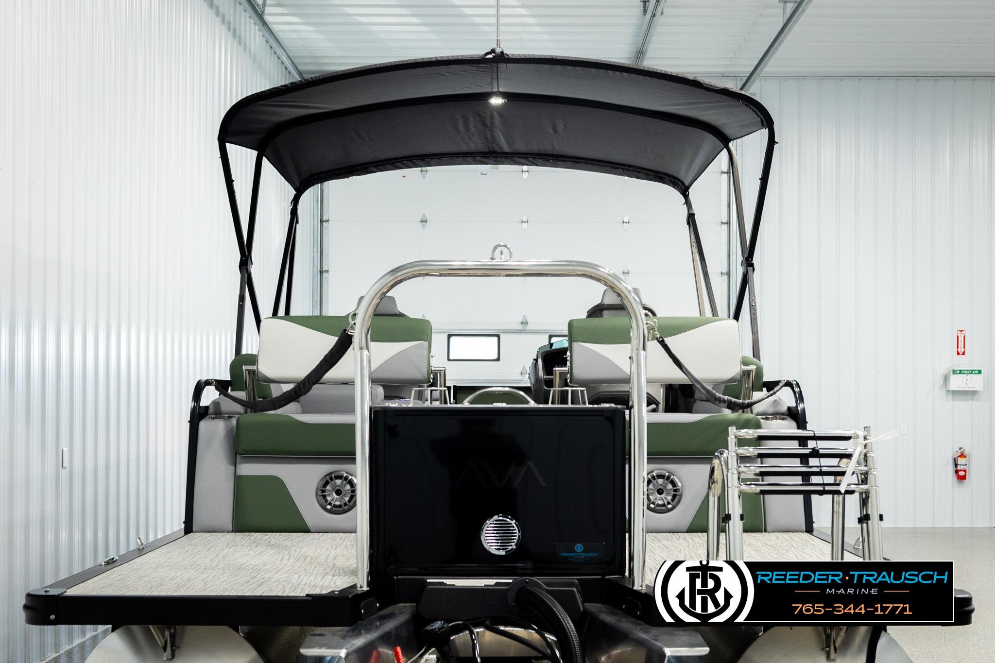 2026 Avalon LSZ QLS pontoon boat in a showroom with canopy and seating.