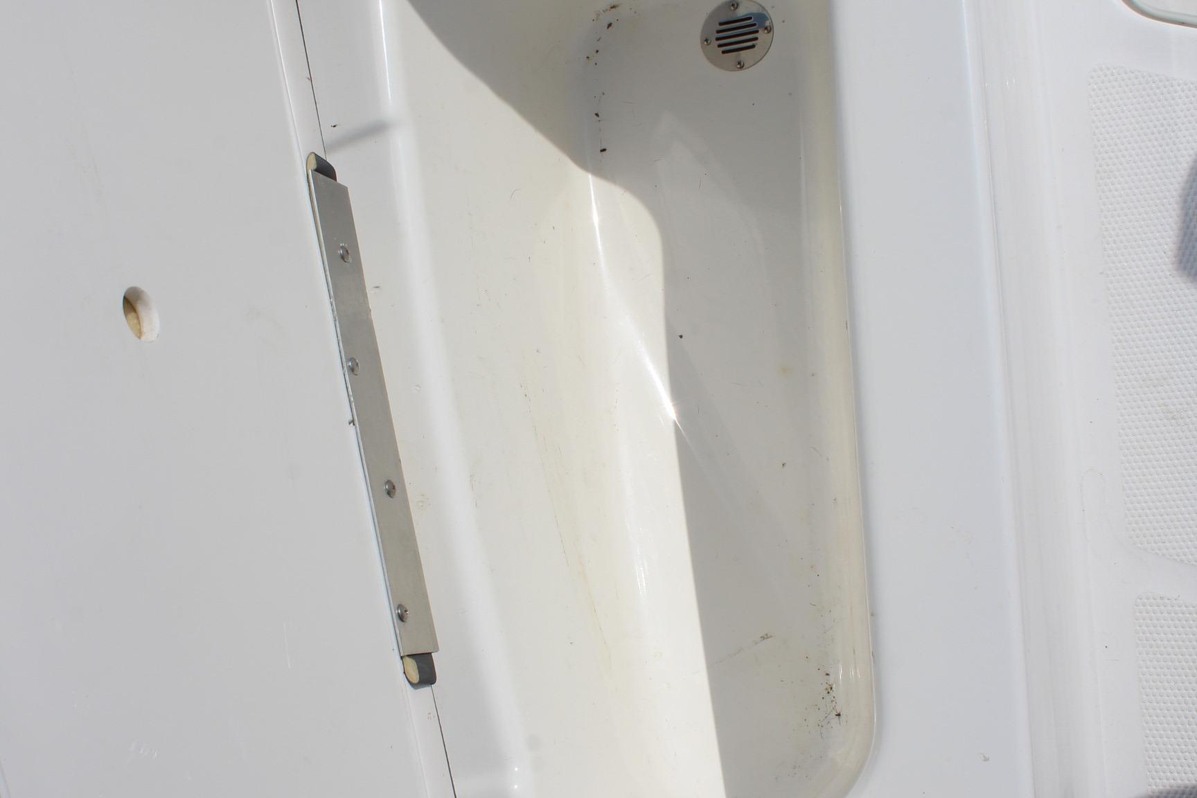 2023 Tahoe T16 boat interior detail with drain and hinge.