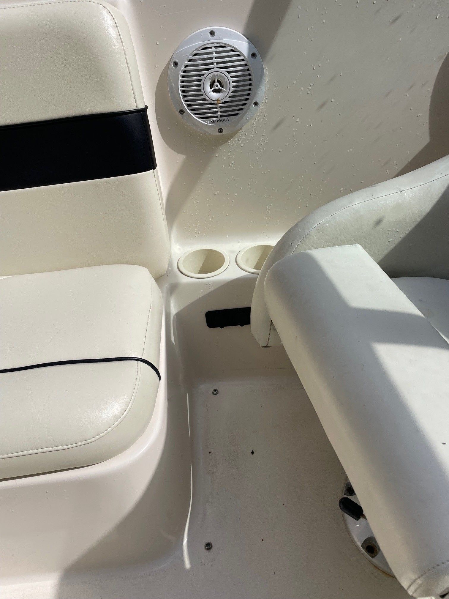 Interior of 2002 Rinker 212 Captiva Bowrider with speaker and seating.