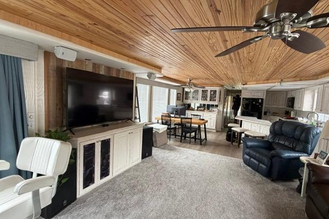 Spacious 1997 Stardust Houseboat interior with wood ceiling, modern kitchen, and cozy living area.