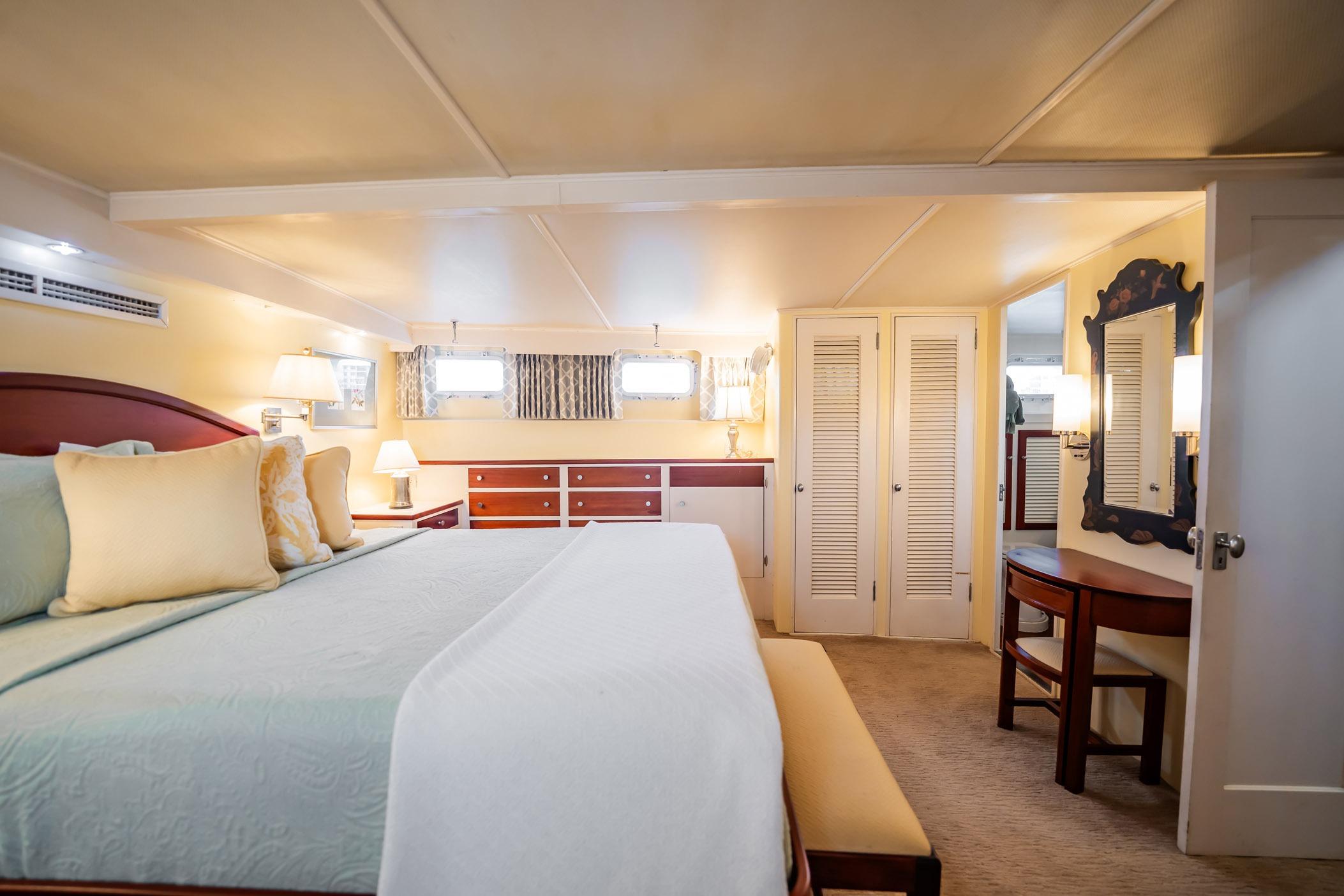 Luxurious bedroom interior of 1972 Trumpy 72 Motor Yacht with elegant furnishings.