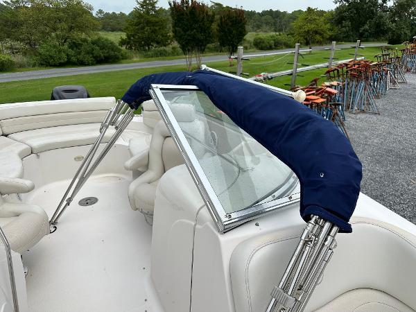 2004 Starcraft Aurora 2410 boat interior with blue canopy and white seating.