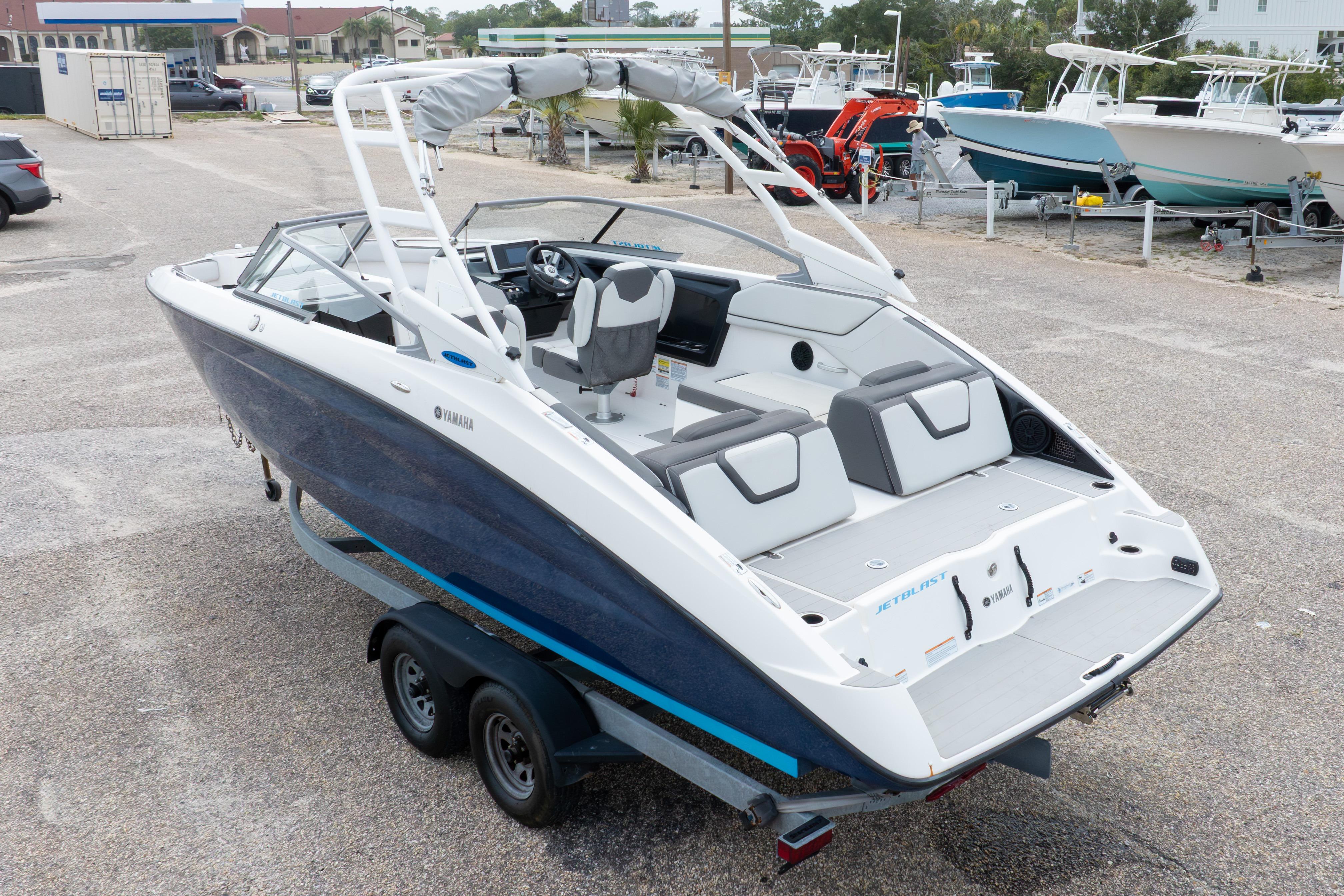 2021 Yamaha Boats AR250 on trailer, featuring sleek design and spacious seating.
