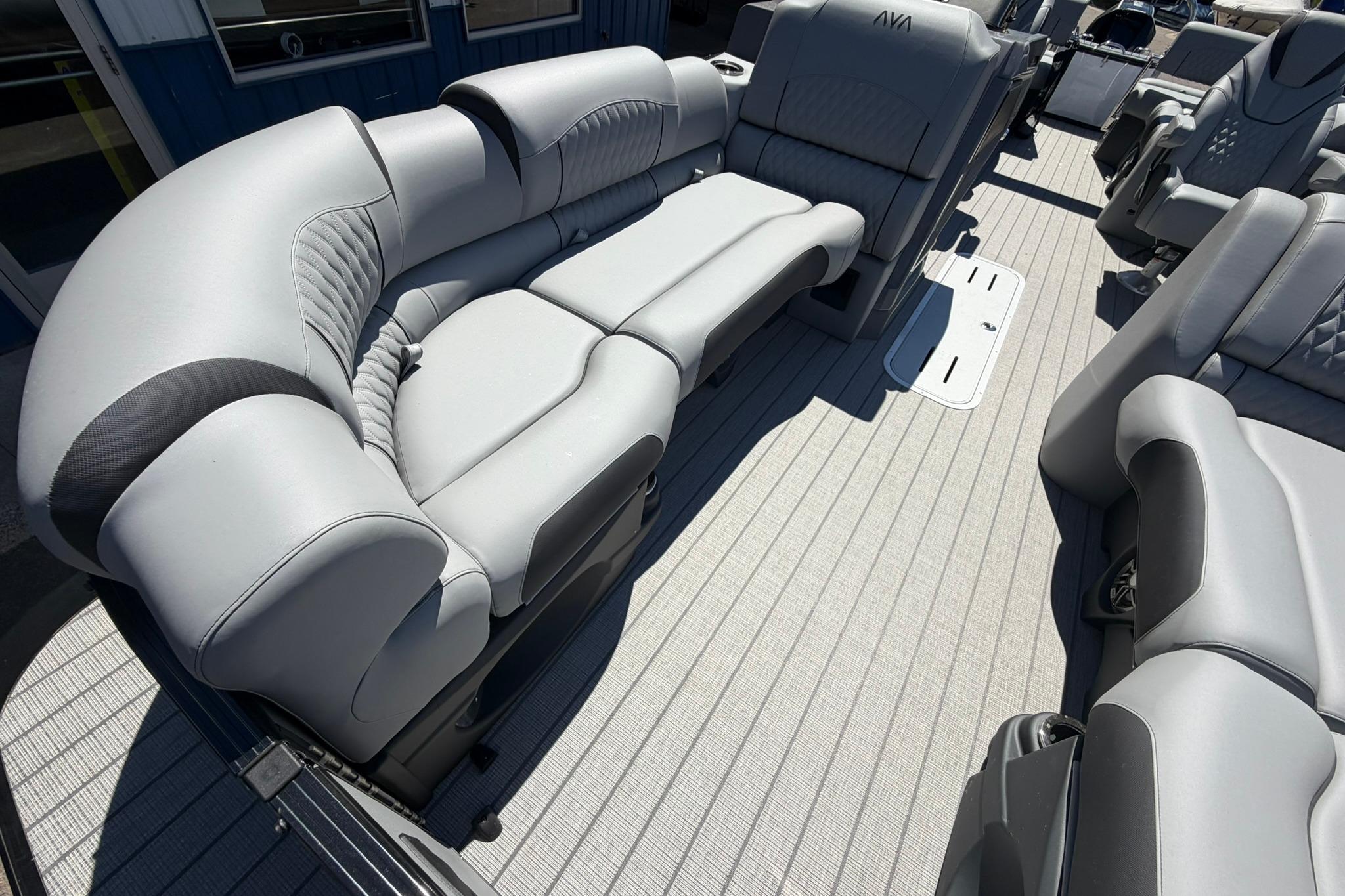 Luxurious seating on 2026 Avalon Catalina Quad Lounge Shift pontoon boat, featuring sleek gray upholstery.