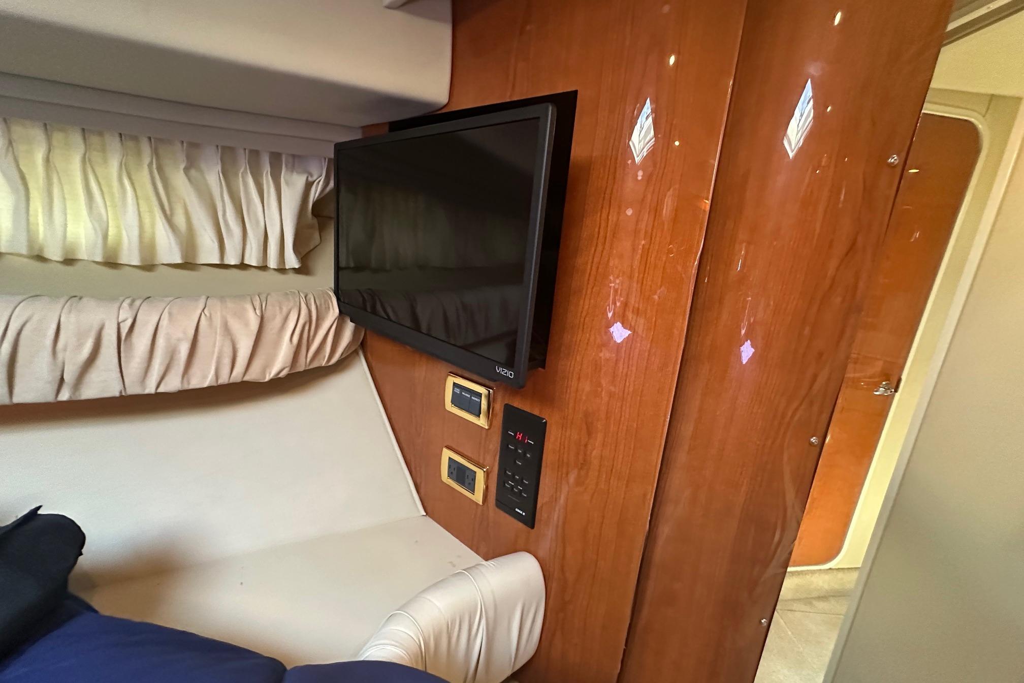 Interior of 2001 Sea Ray 410 Sundancer with TV and wood paneling.