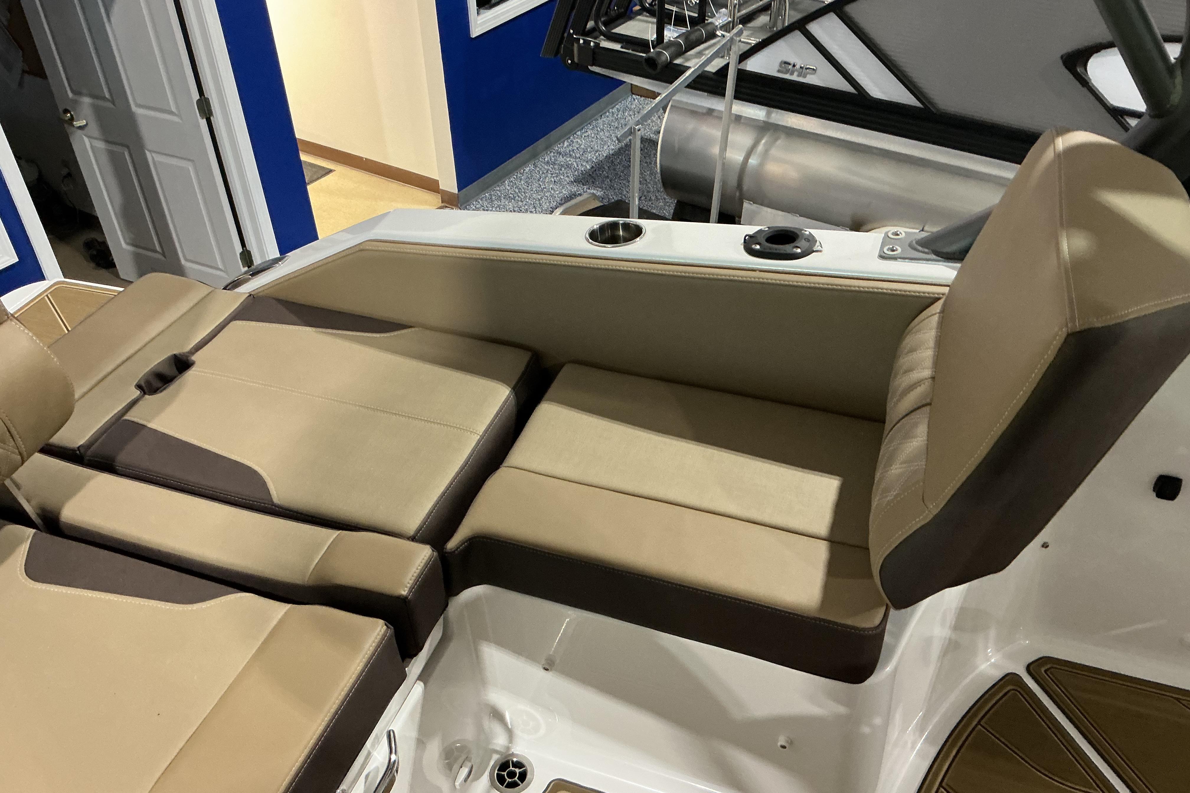 2026 Monterey Elite 25 OB boat interior with beige seating and cup holders.
