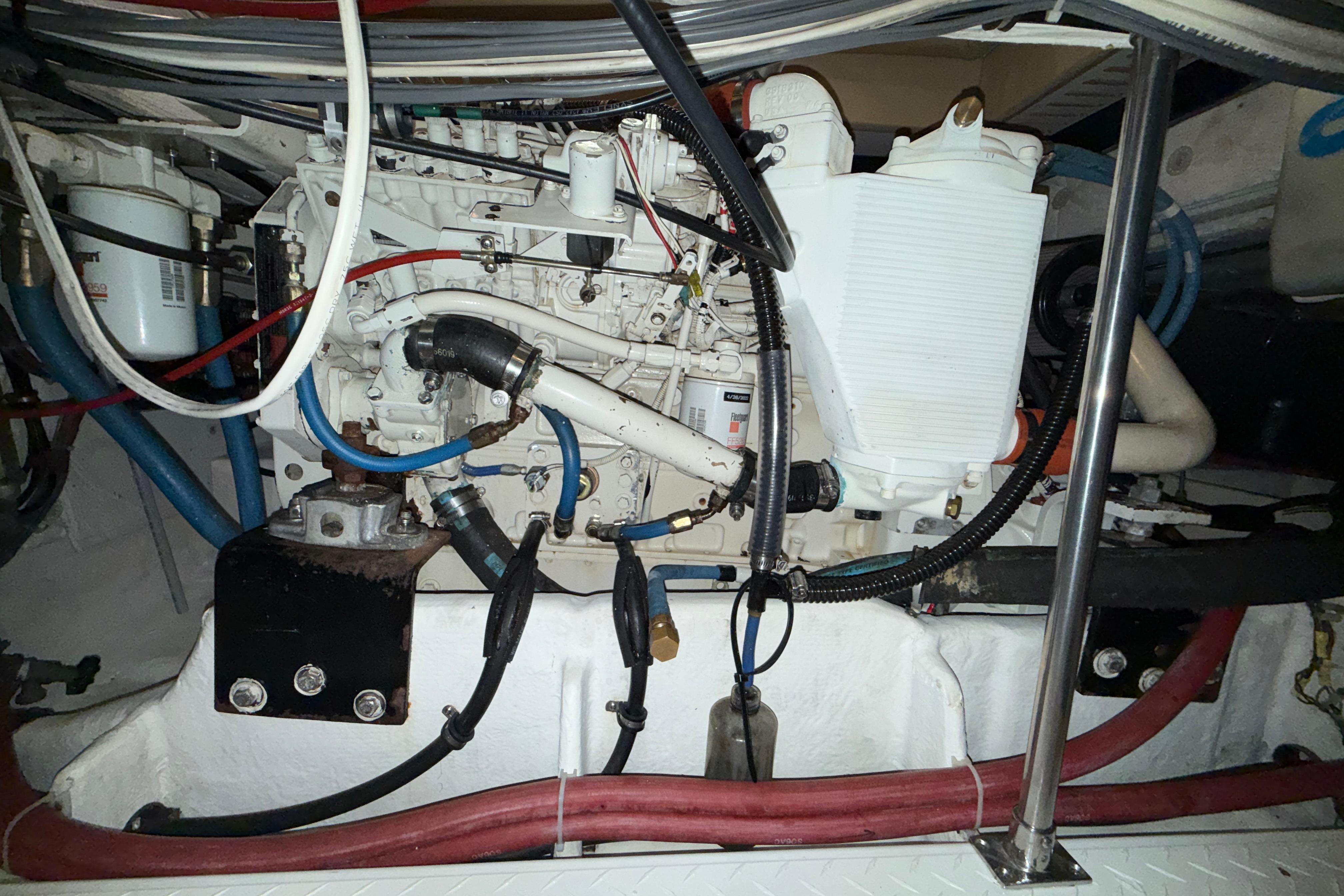 Engine compartment of a 1998 Bayliner 4788 Pilot House Motoryacht, showcasing mechanical components.