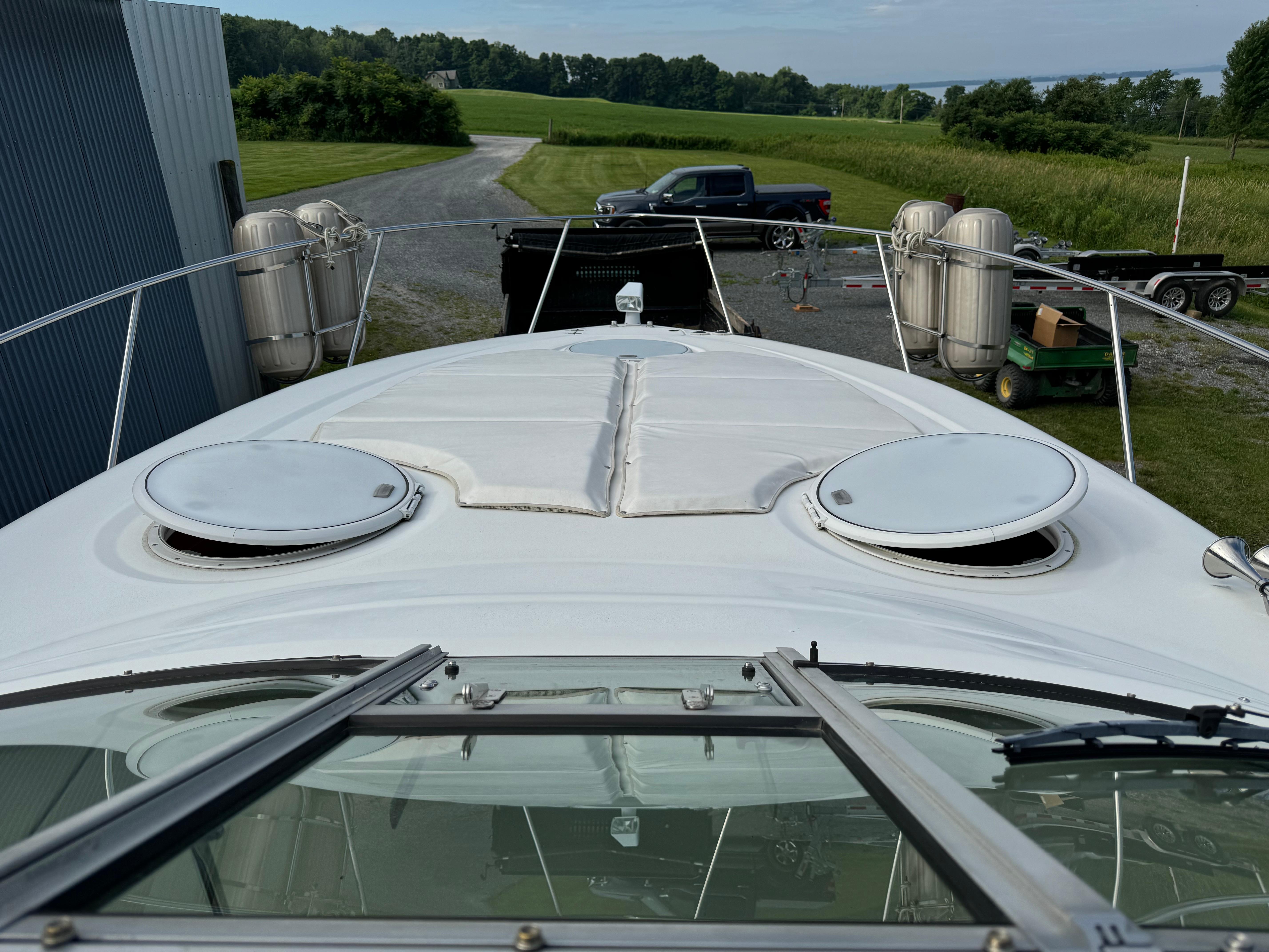 2005 Four Winns 328 Vista boat docked, showing deck and surrounding countryside.
