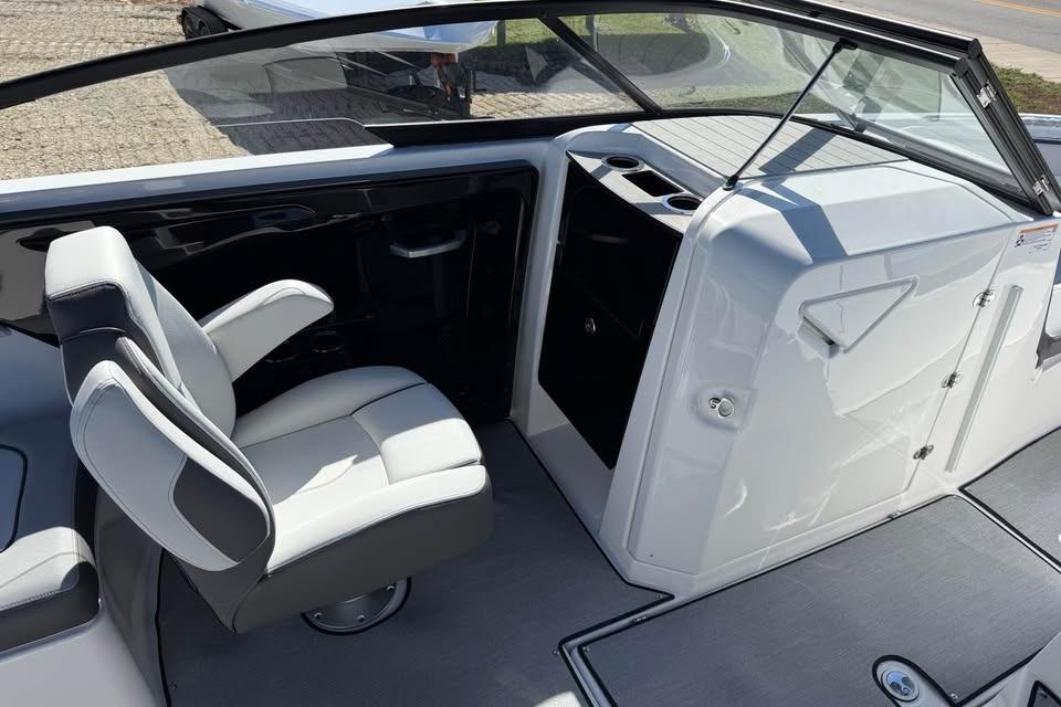 Interior view of 2026 Yamaha Boats AR250, featuring a sleek captain's chair and modern dashboard.