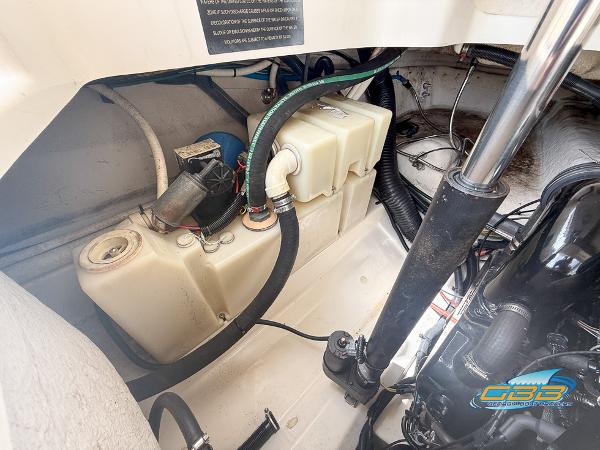 Engine compartment of a 2008 Sea Ray 270 SLX boat, showing mechanical components and fluid reservoirs.