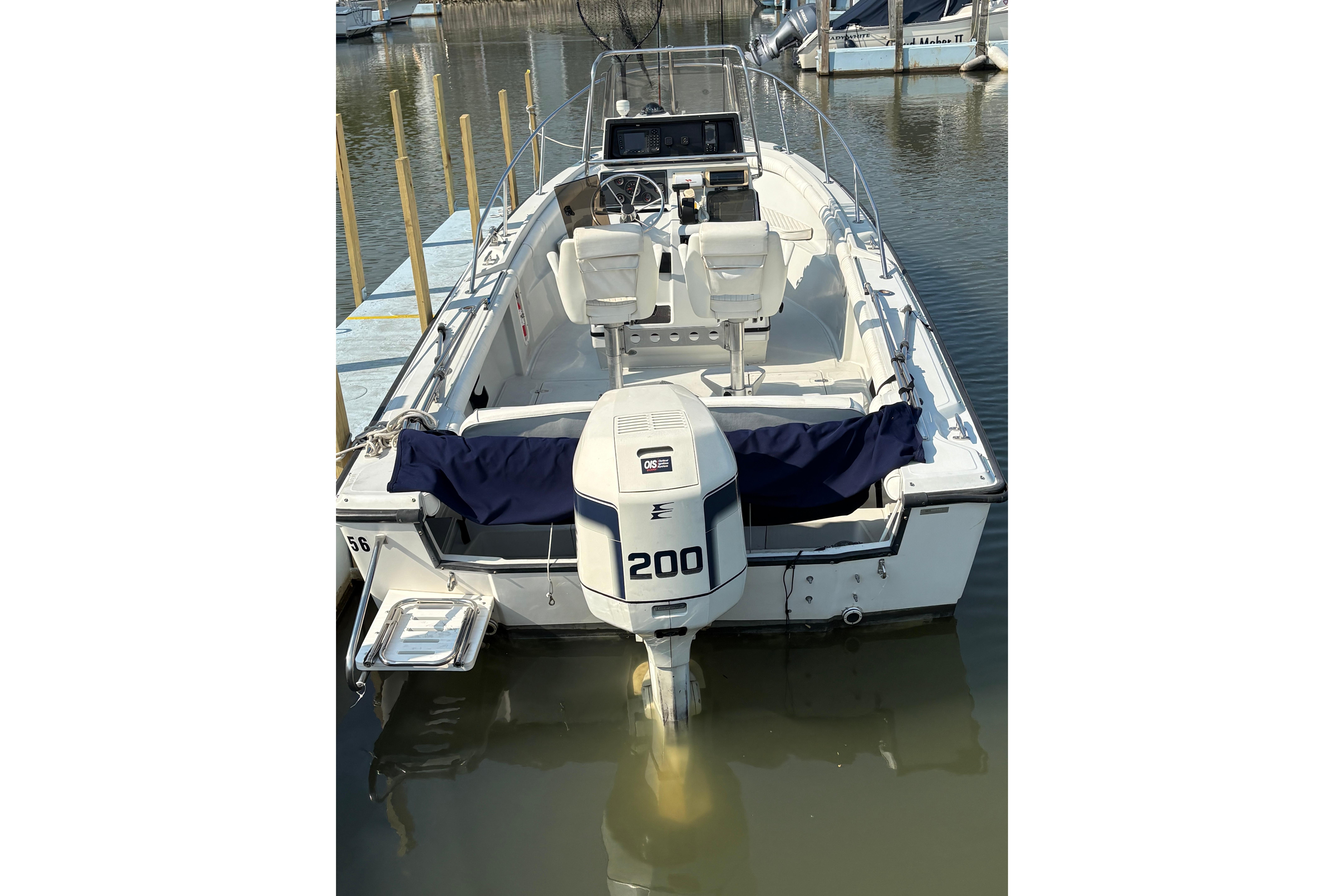 1993 Boston Whaler 21 Outrage boat with 200 HP engine docked in marina.