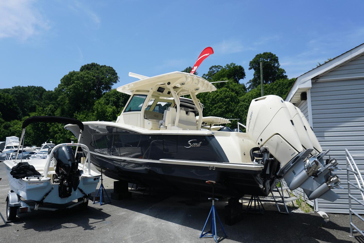 2024 Scout 357LXF boat displayed outdoors with dual engines.