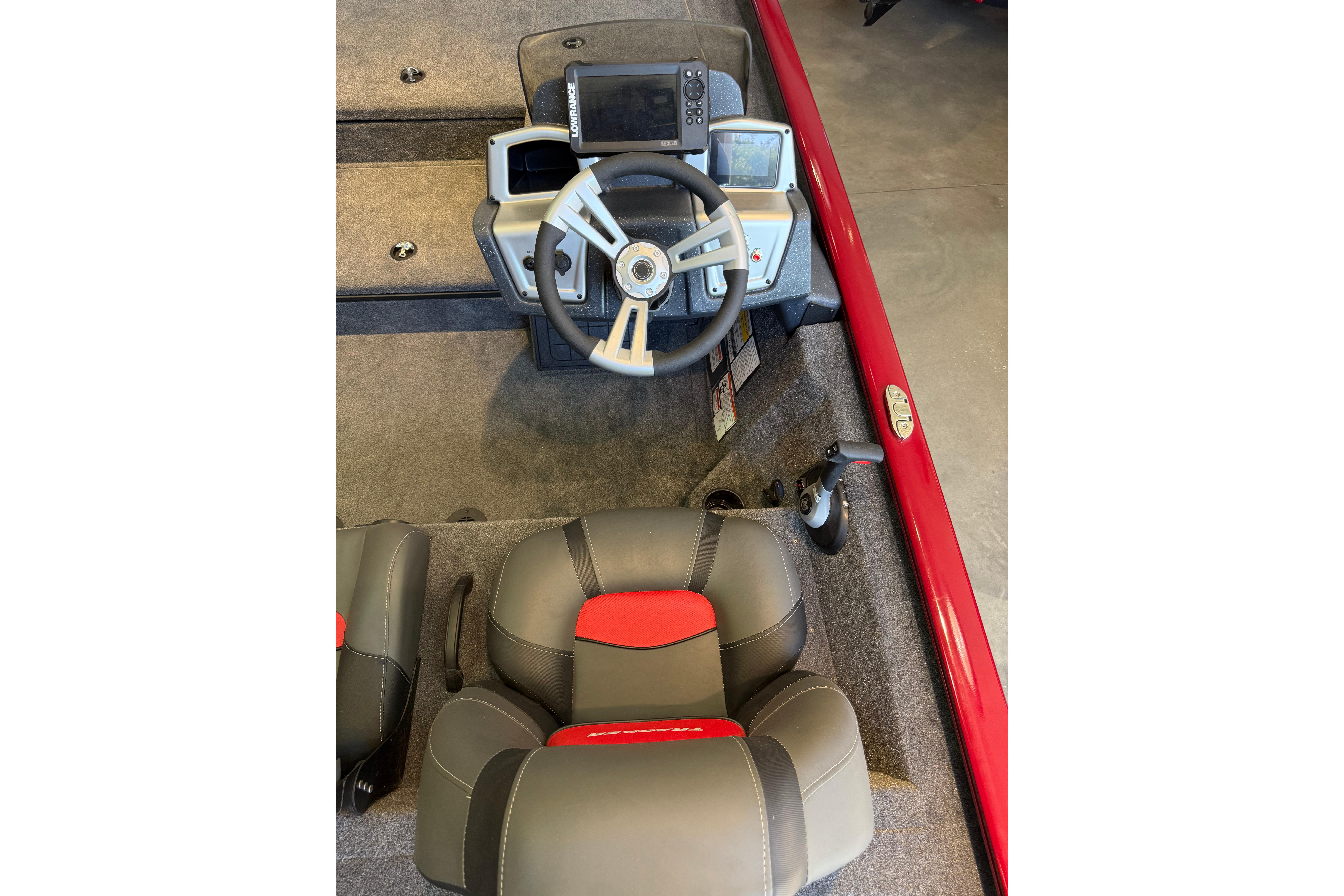 2025 Tracker Savage 215 boat interior with steering wheel and seats, featuring modern controls.