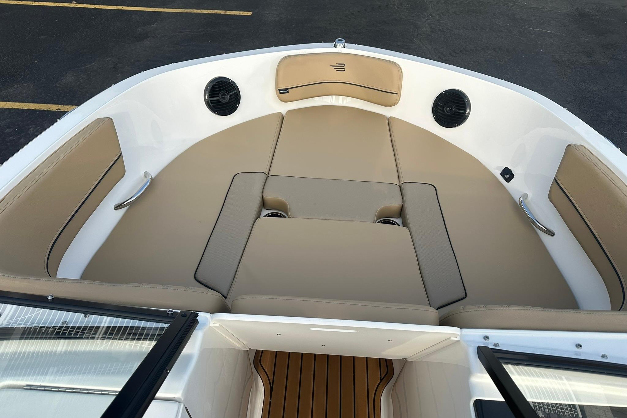 2026 Bayliner VR6 Bowrider OB interior with tan seating and integrated speakers.