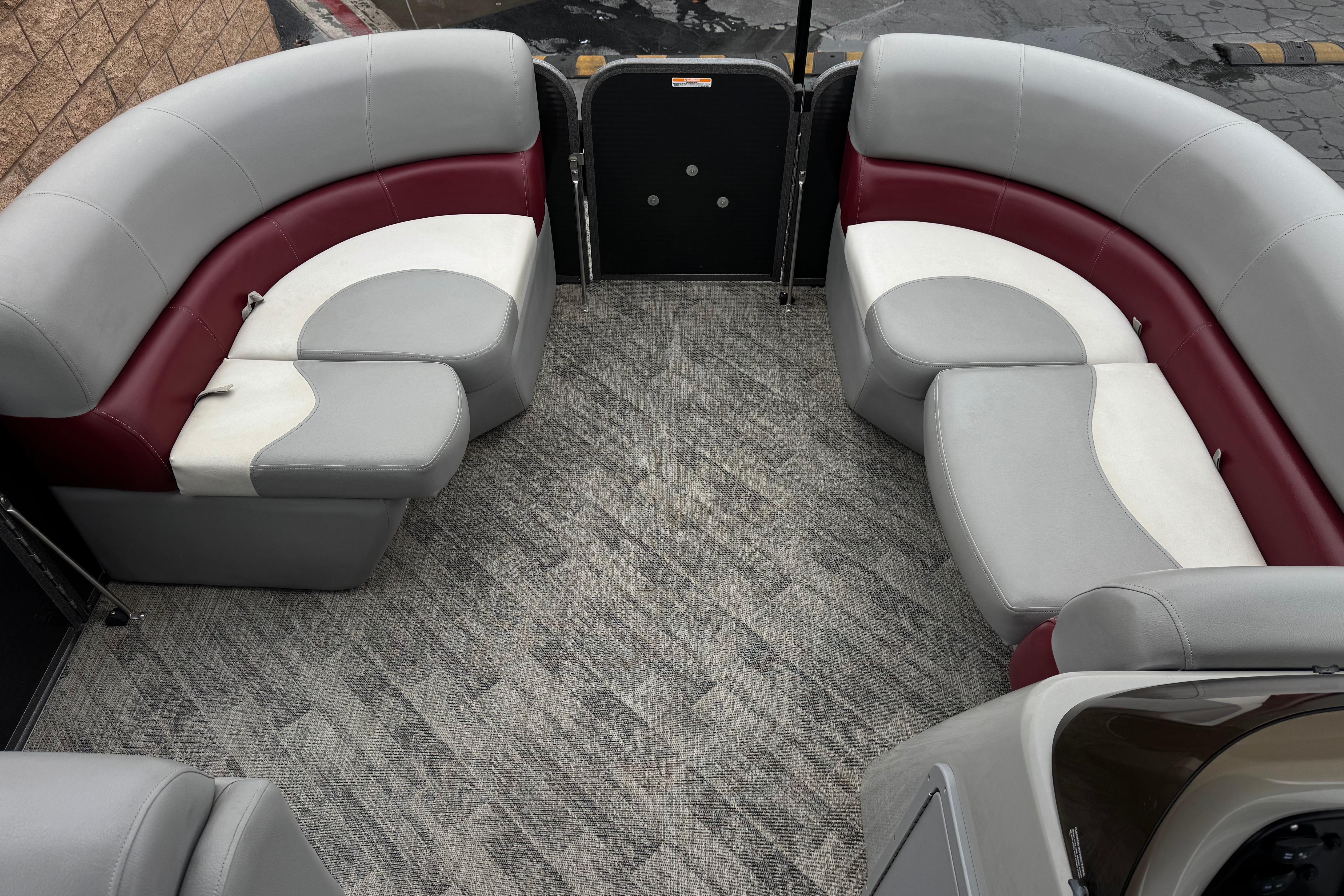 2020 Manitou 18 Aurora LE pontoon boat interior with gray and maroon seating.