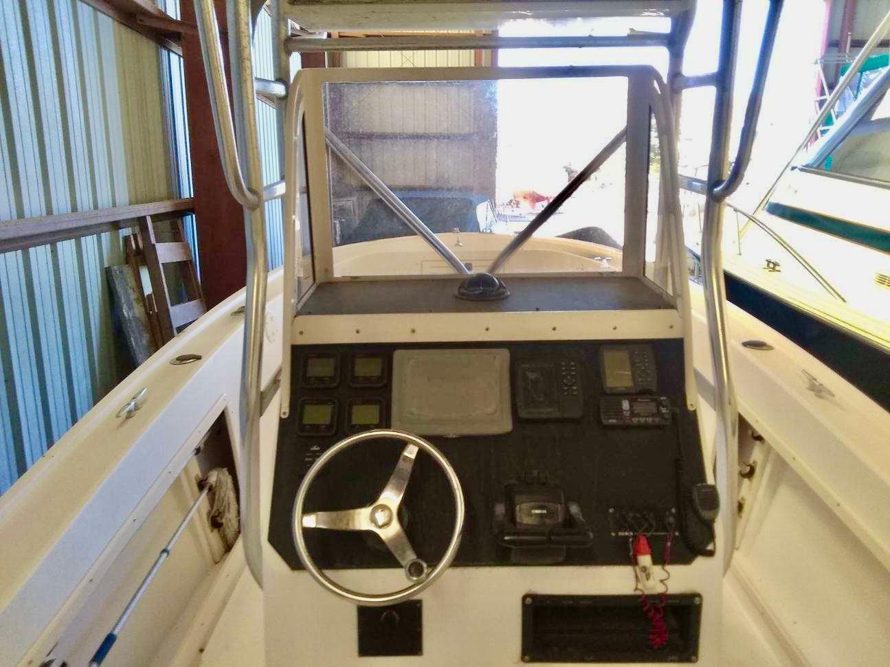 1996 Mako 262 Center Console boat dashboard with steering wheel and navigation controls.