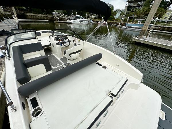2022 Bayliner DX 2050 boat docked, featuring spacious seating and modern design.