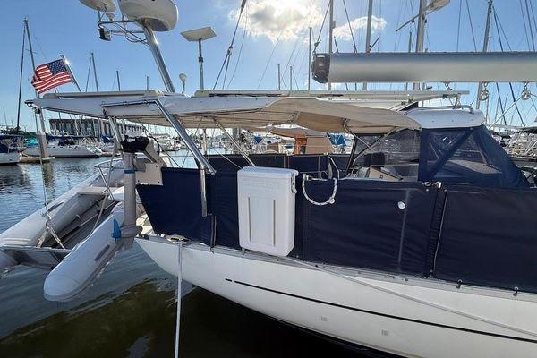 Sailboat "Reliance 44" (2011) docked, featuring a covered deck and American flag.